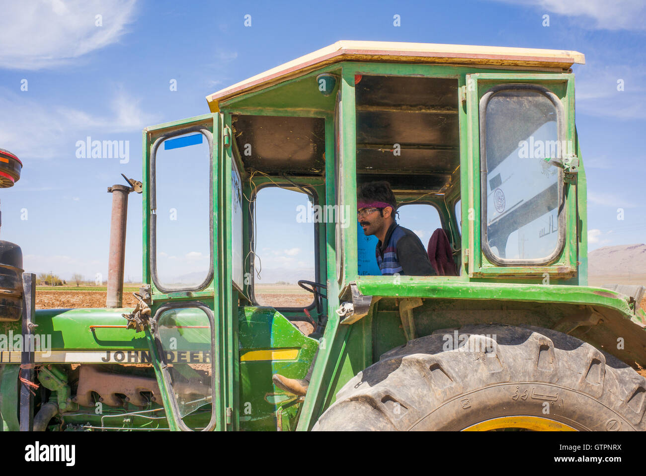 Farmer discing his fields in rural Fars Province, Iran, with John Deere