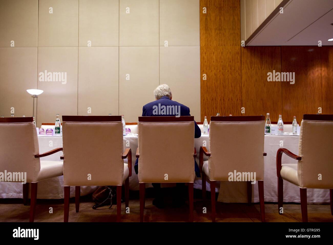 U.S Secretary of State John Kerry reviews documents alone amid negotiations with Russian Foreign Minister Sergey Lavrov on Syria at the Hotel President Wilson September 9, 2016 in Geneva, Switzerland. Russia and the United States reached agreement on a joint approach to Syria. Stock Photo