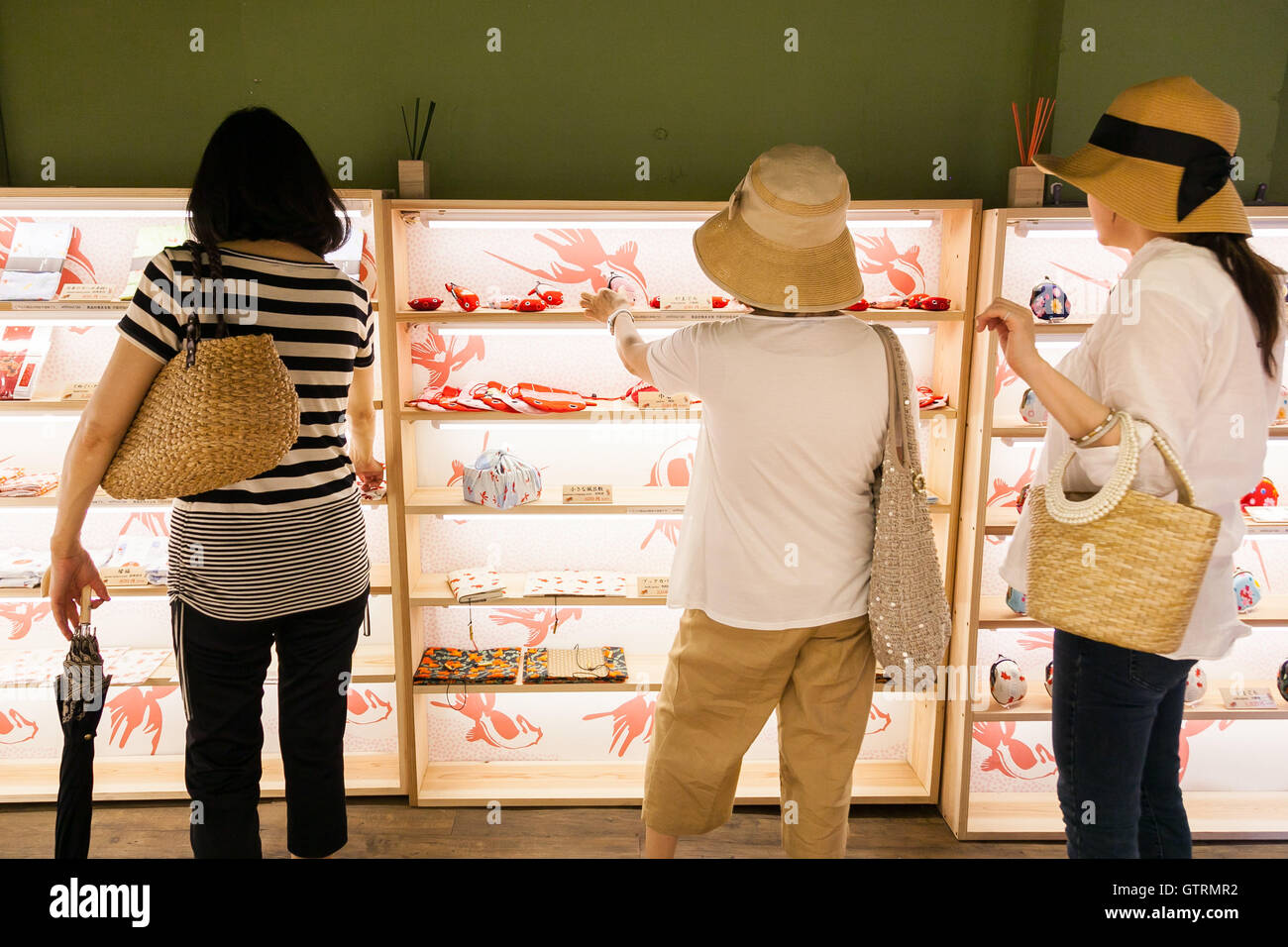 Customers look at the Japanese traditional gifts with kingyo (goldfish) illustrations at the Asakusa Kingyo store on September 9, 2016, Tokyo, Japan. Asakusa Kingyo is a goldfish concept store where customers can buy various kinds of traditional Japanese goldfish shaped gifts. The store also challenges customers to play the Goldfish Scooping Game to scoop goldfish or discount coupons. The store opened two months ago, and customers, especially foreigners, who have never been to a Japanese summer festival have the opportunity to enjoy the traditional game. (Photo by Rodrigo Reyes Marin/AFLO) Stock Photo
