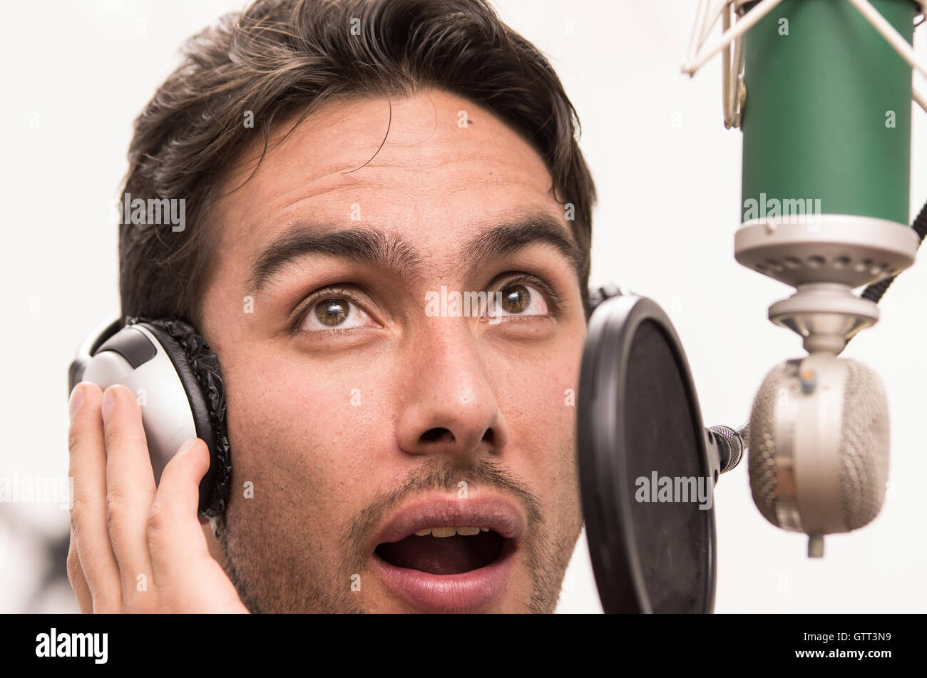 handsome man singing in music studio Stock Photo - Alamy