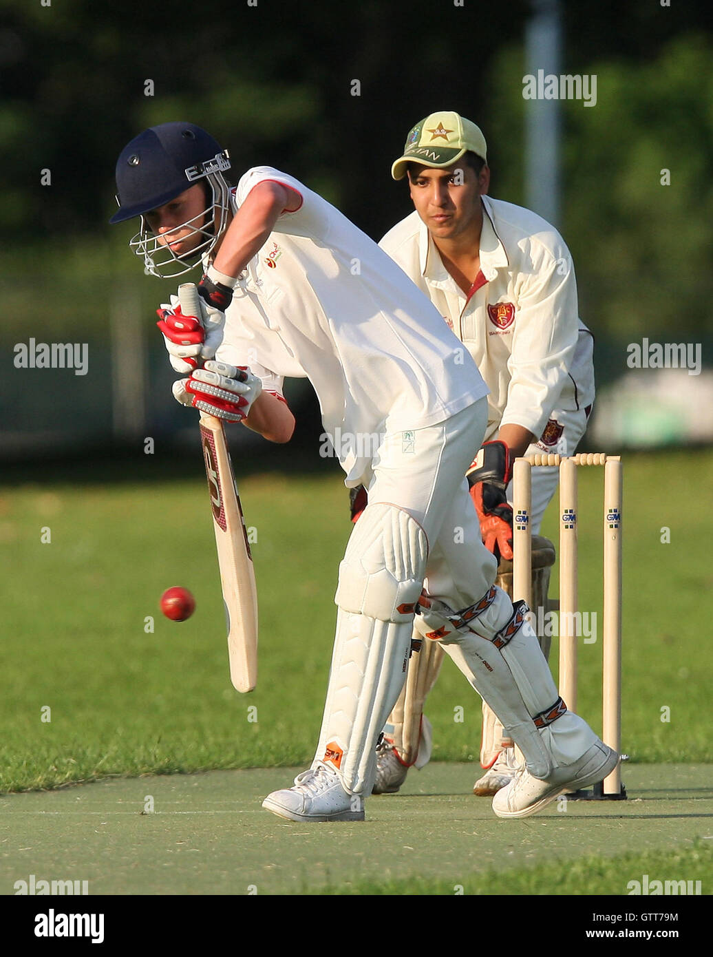 Scott in batting action for VPJ as Raja looks on from behind the stumps - Victoria Park Juniors vs Goodmayes - Victoria Park Community Cricket League - 09/06/08 Stock Photo
