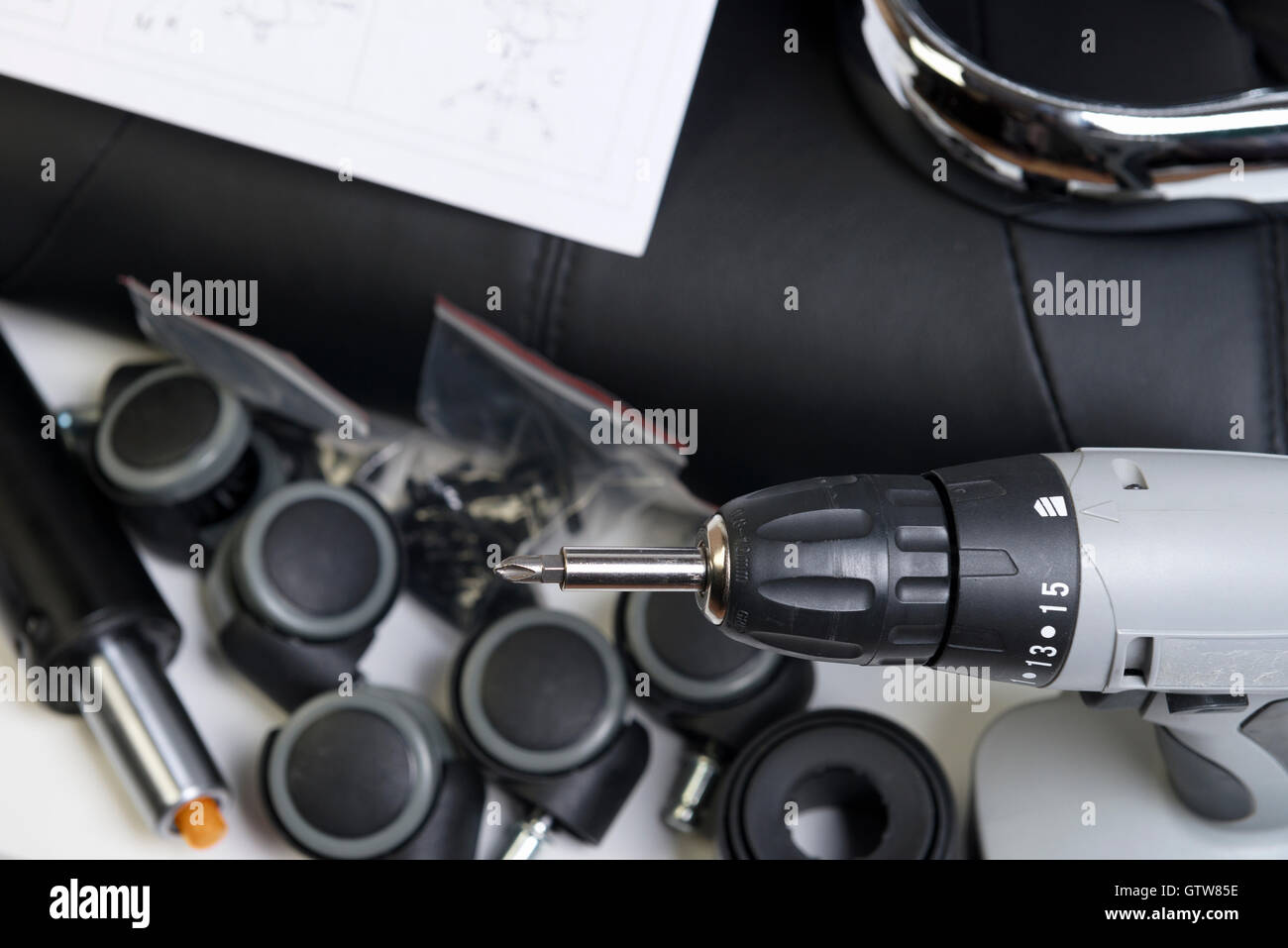 a complete set of components for assembly of an office chair on a white