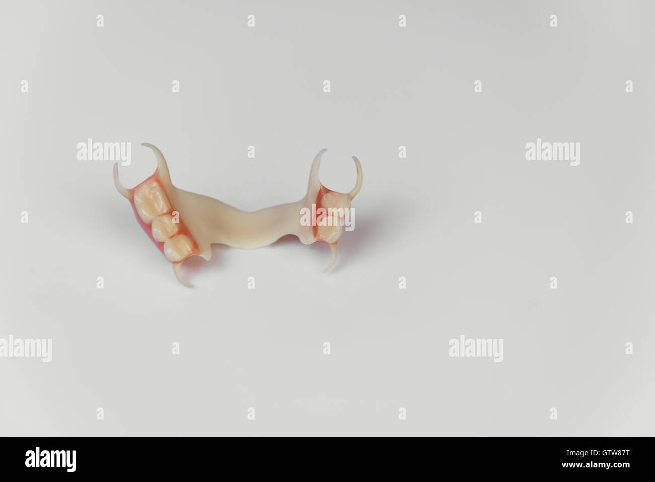 A denture clasp on a white background Stock Photo Alamy