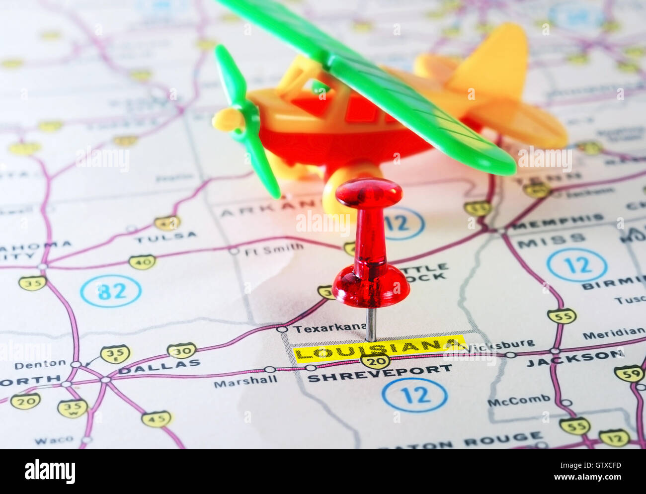 Close up of  Louisiana USA map with red pin and airplane toy - Travel concept Stock Photo