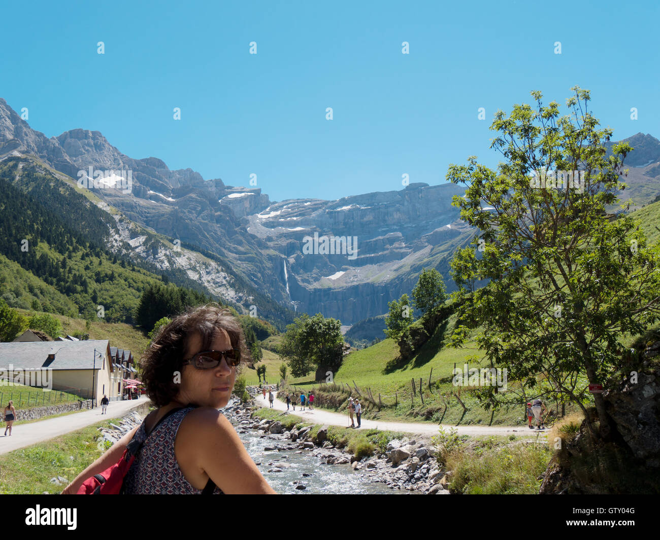 A woman hiker and cirque de Gavarnie in the French pyrenees mountains ...