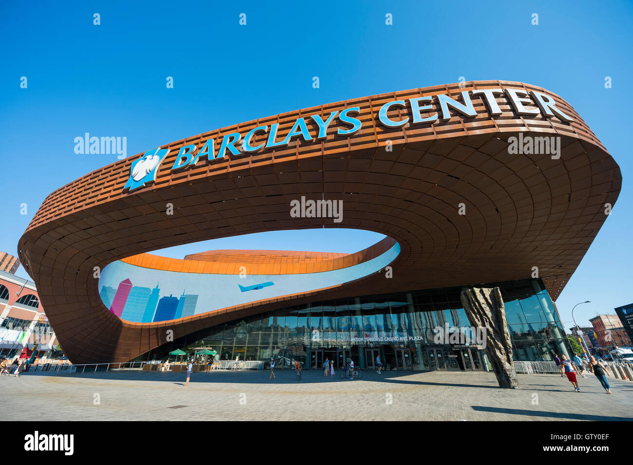 NEW YORK CITY - AUGUST 30, 2016: Pedestrians pass under the distinctive architecture of the Barclays Center sports complex. Stock Photo