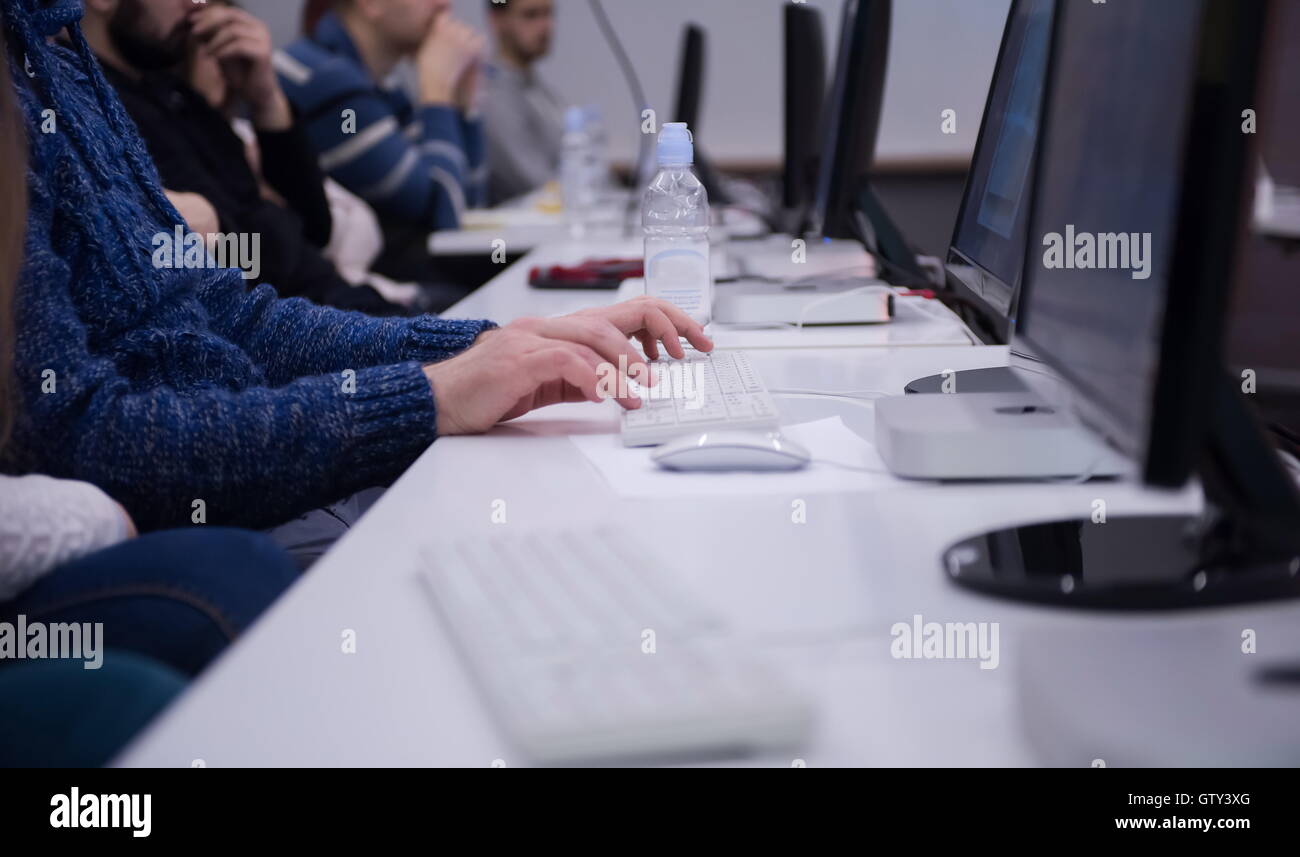 it students on listening presentation and taking notes on laptop computer Stock Photo