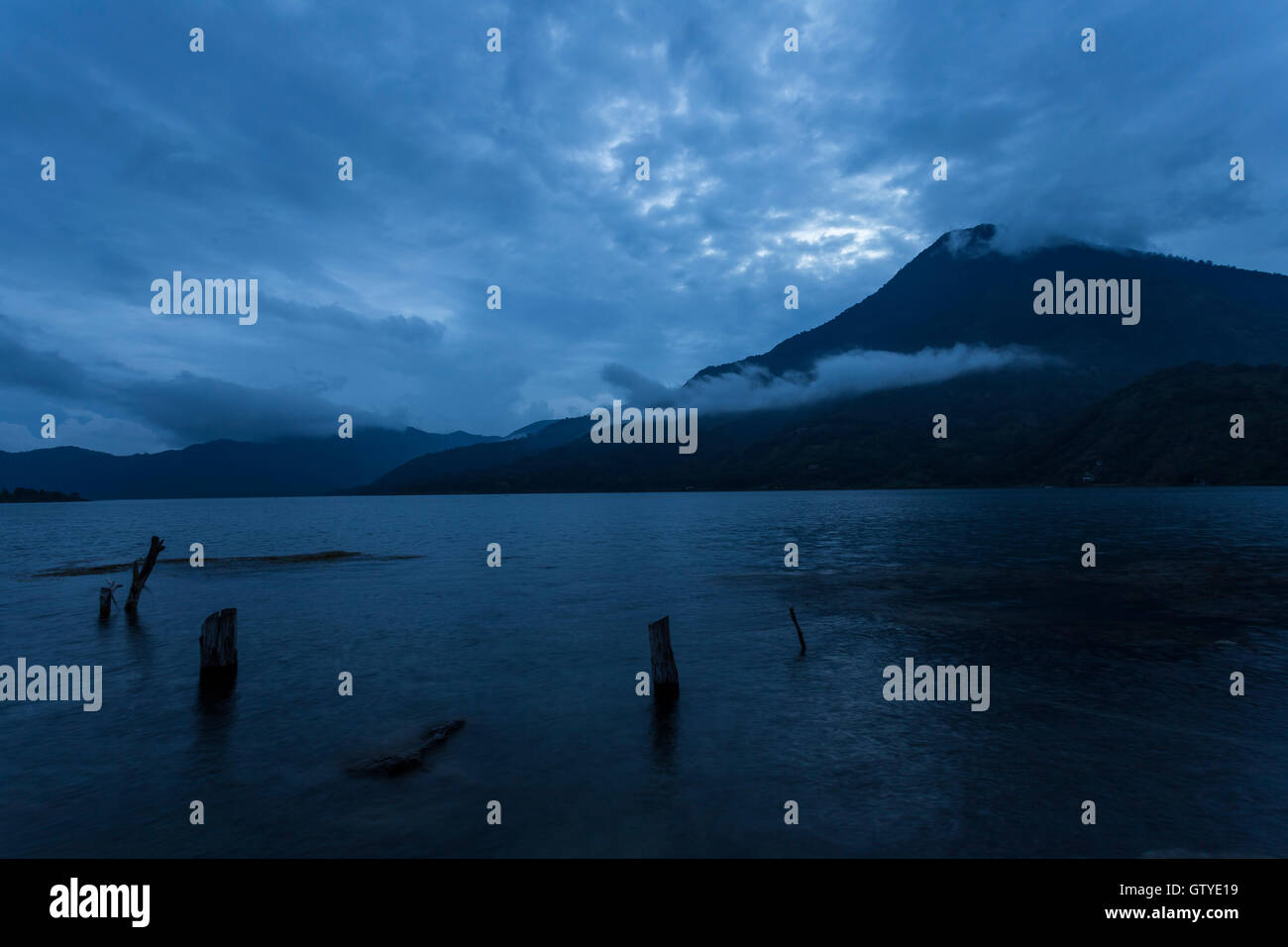 A calm and serene scene of the San Pedro Volcano from Santiago Atitlan at dusk. Stock Photo
