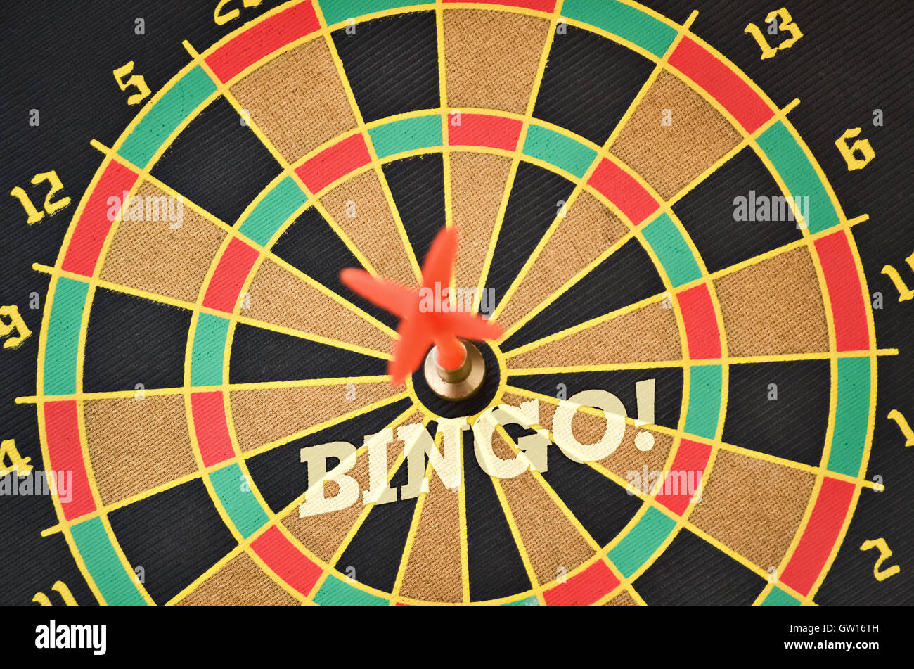 Word Bingo written on the circular target with a plastic feather in the center Stock Photo