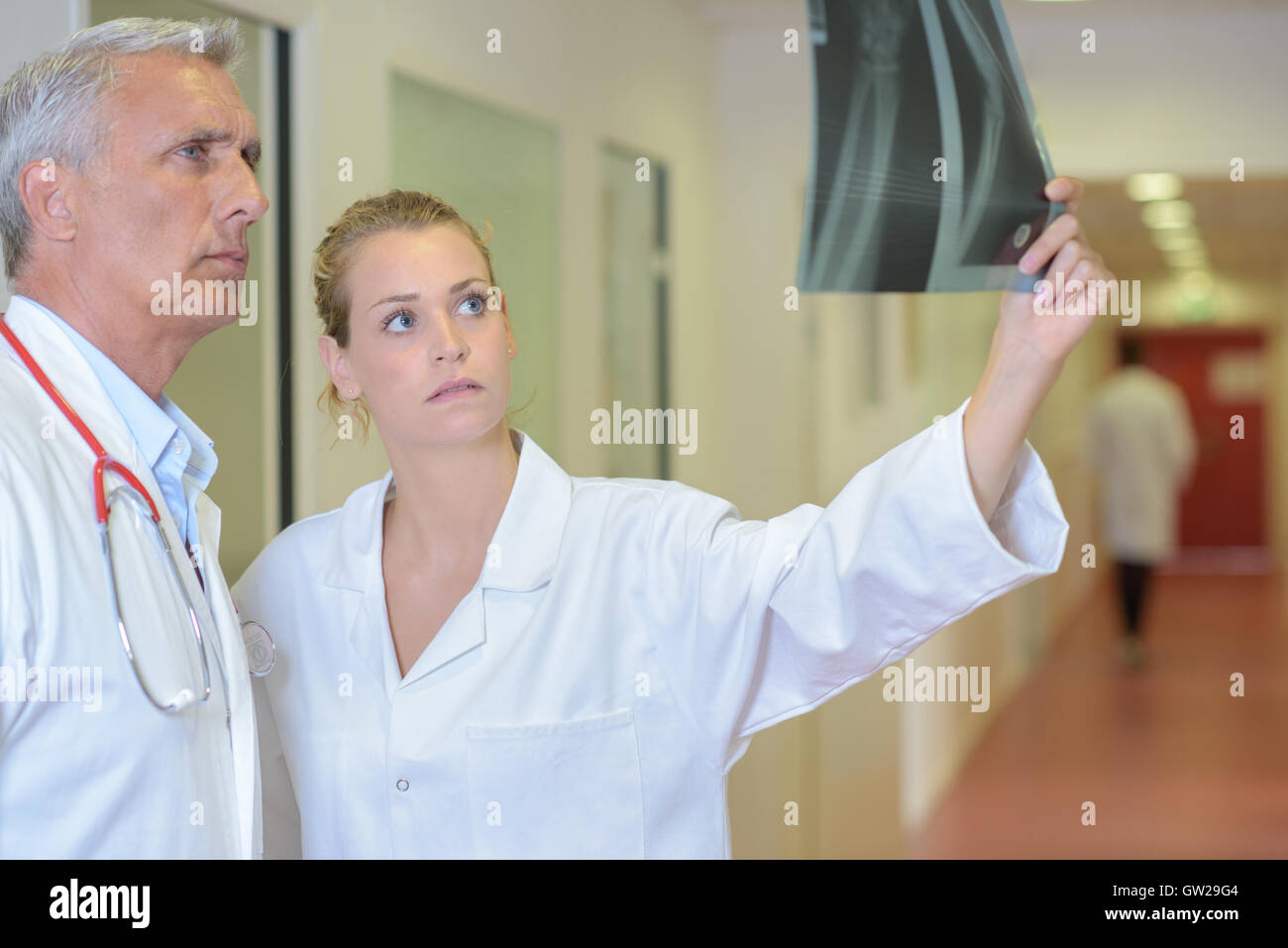 Two medics looking at xray Stock Photo - Alamy