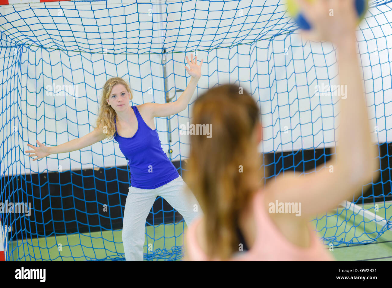 Woman defending handball goal Stock Photo