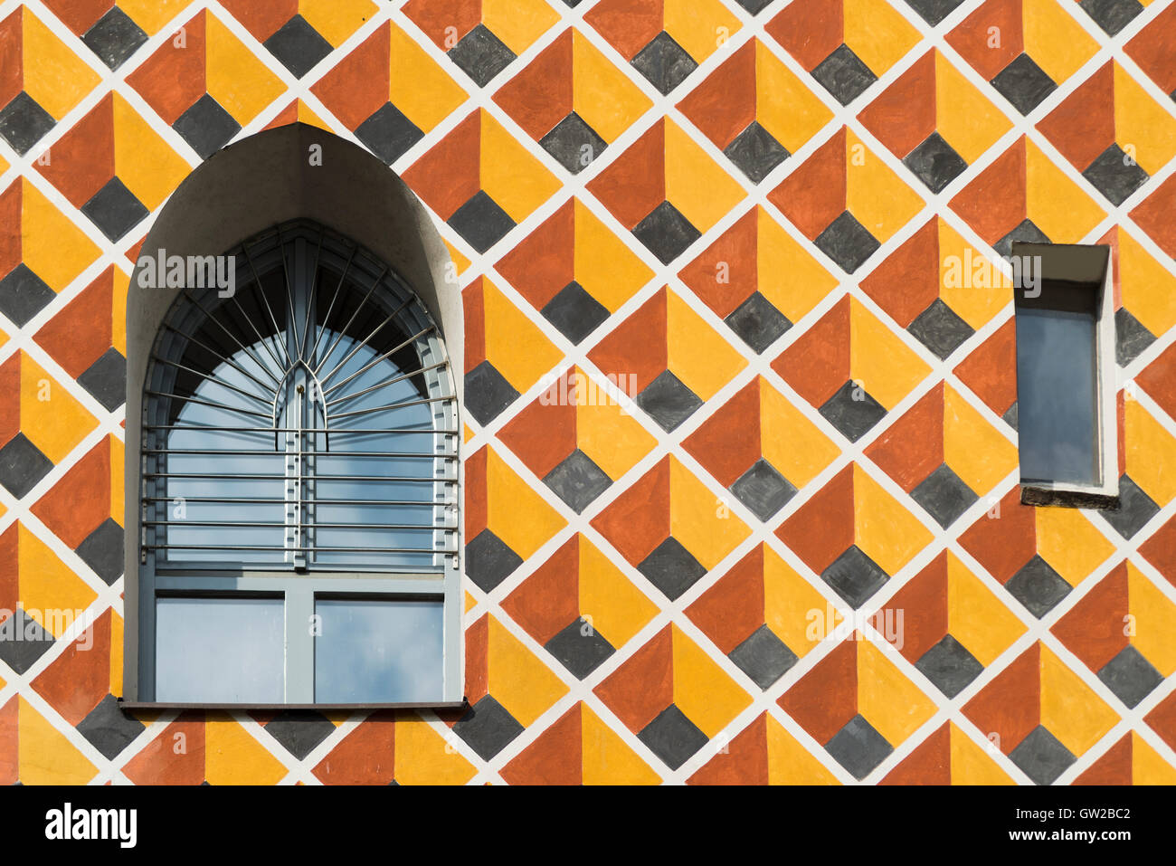 Windows in a colorful patterned facade of a medieval house in ...