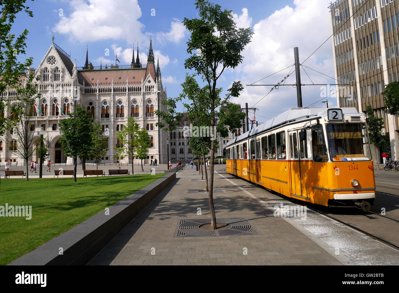 A tram trundles past the Parliament building, designed by Imre Steindl in 1885, Budapest, Hungary Stock Photo