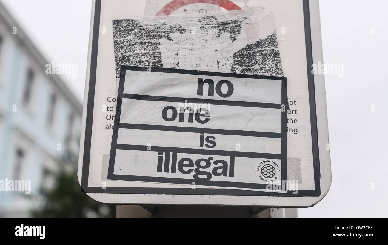 Sticker on a street lamp with words 'no one is illegal'. It refers to the the European migrant crisis or European refugee crisis Stock Photo