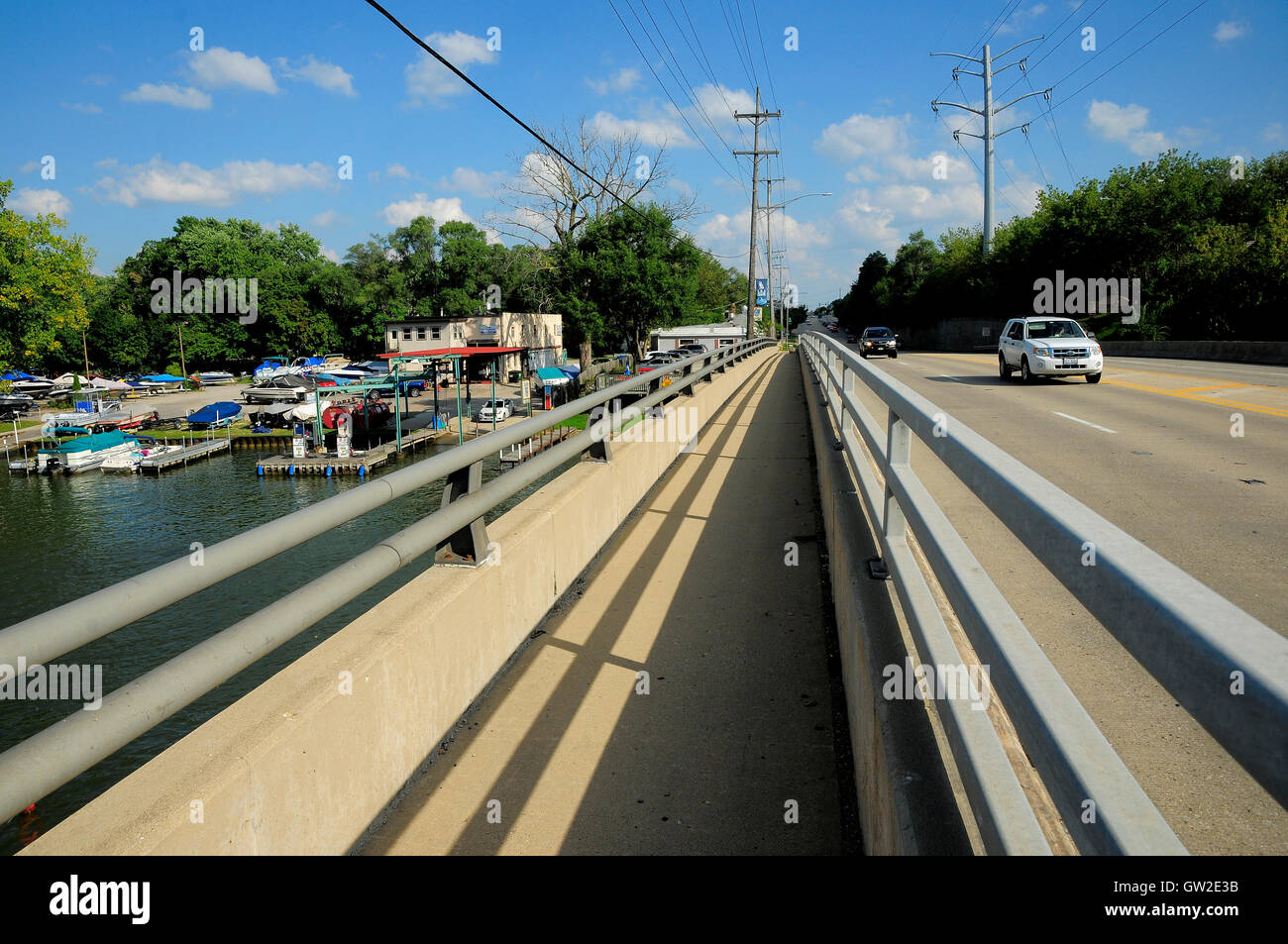 Bridge over river with marina on left Stock Photo