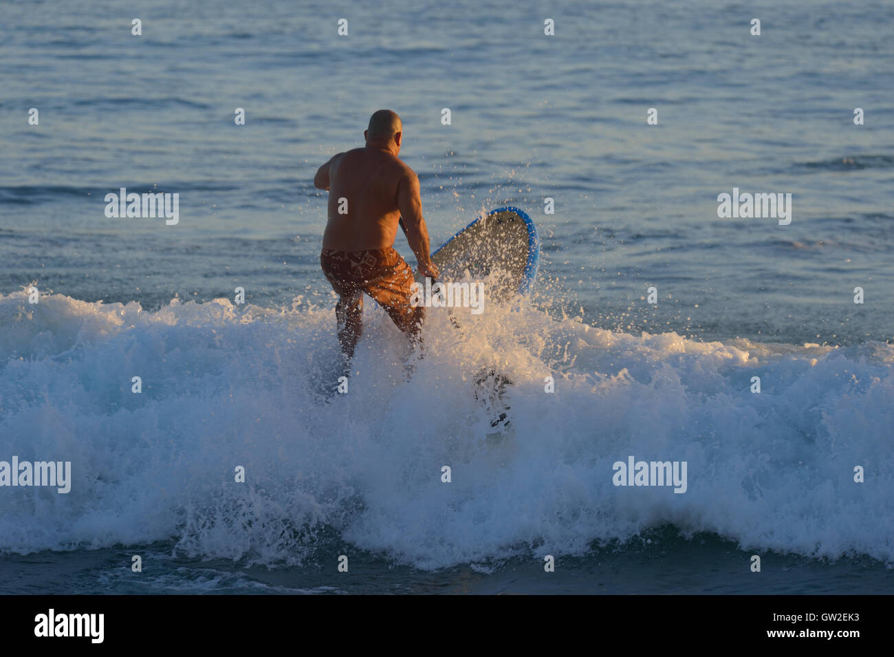 Water activities during sunset at Waikiki beach, Honolulu HI Stock