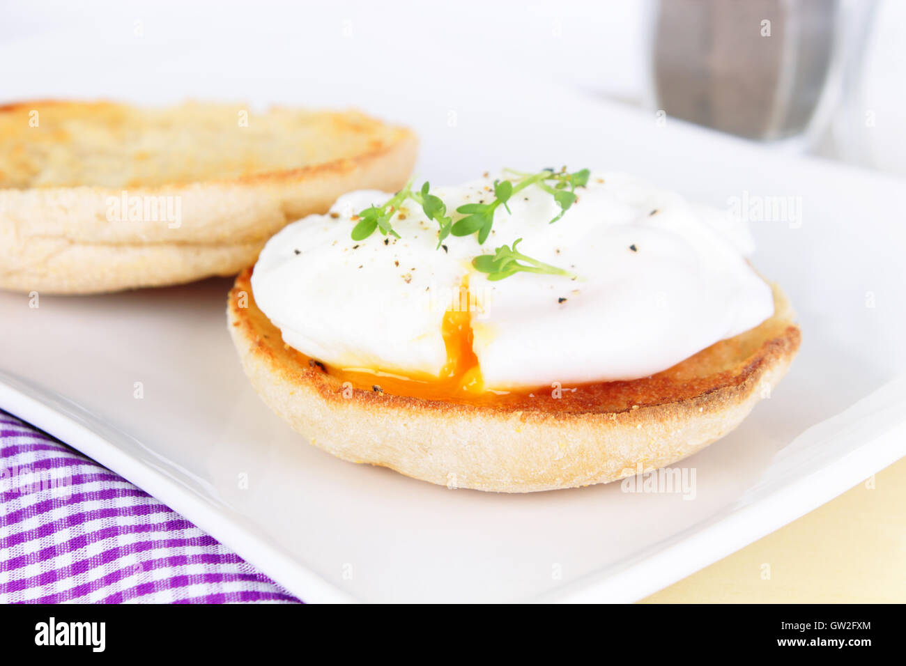 poached egg on english muffin with watercress Stock Photo