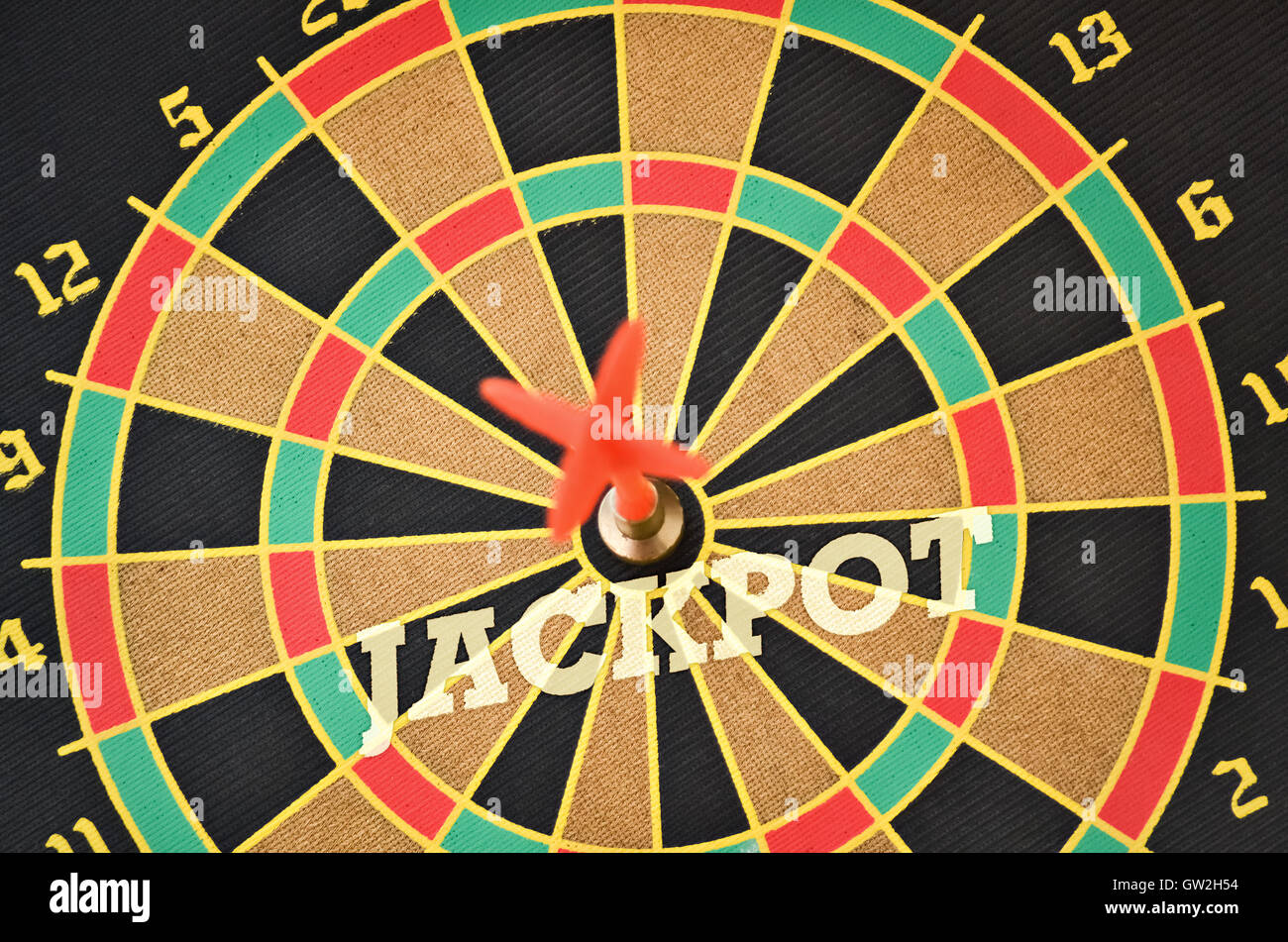 Word Jackpot written on the circular target with a plastic feather in the center Stock Photo