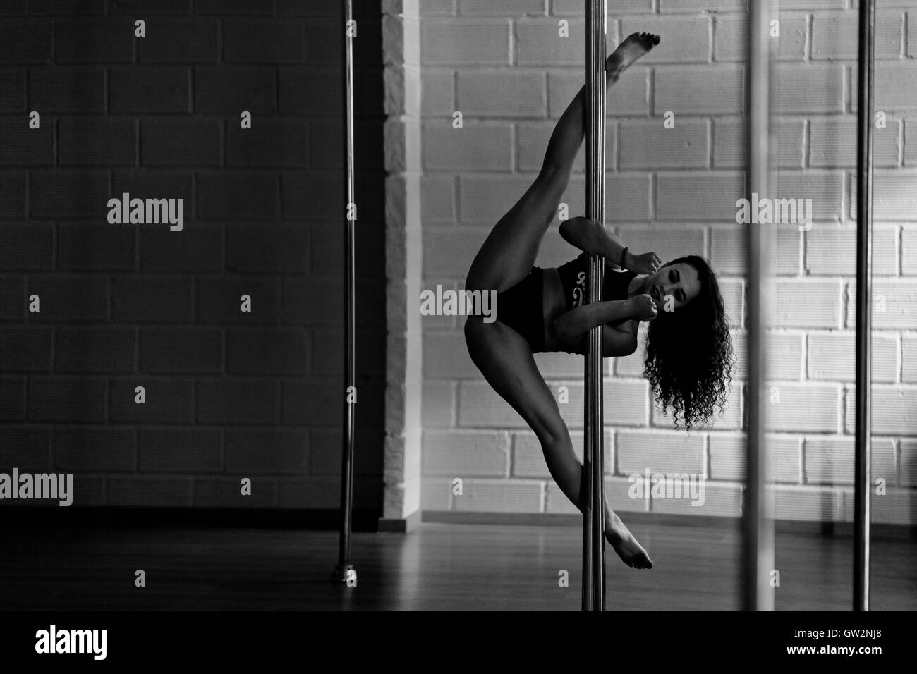 Carolina Echavarria, a young Colombian pole dancer, grips a pole with her  forearms during a pole dance training session in Academia Pin Up in  Medellín, Colombia Stock Photo - Alamy