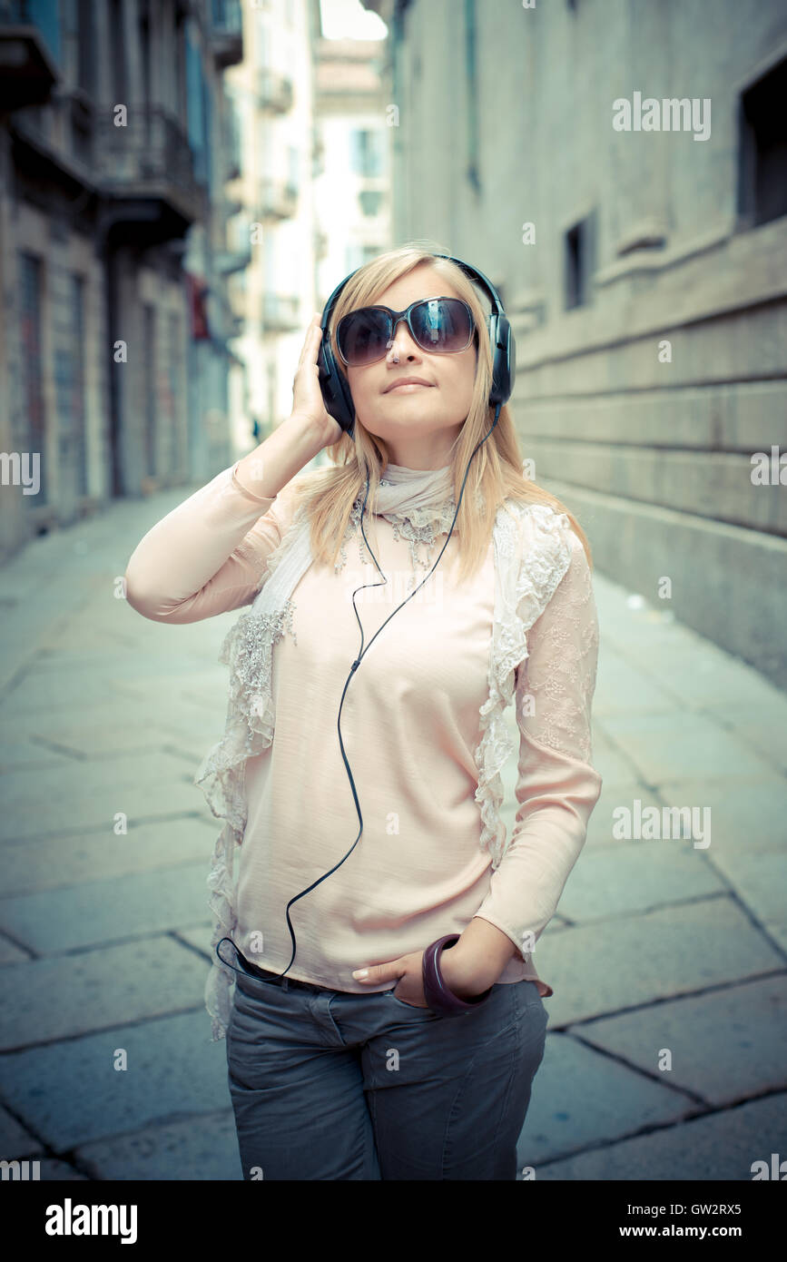 beautiful blonde woman listening to music Stock Photo - Alamy