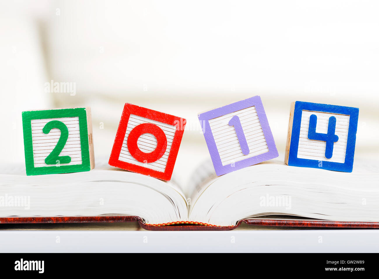 Alphabet block with 2014 on book Stock Photo - Alamy