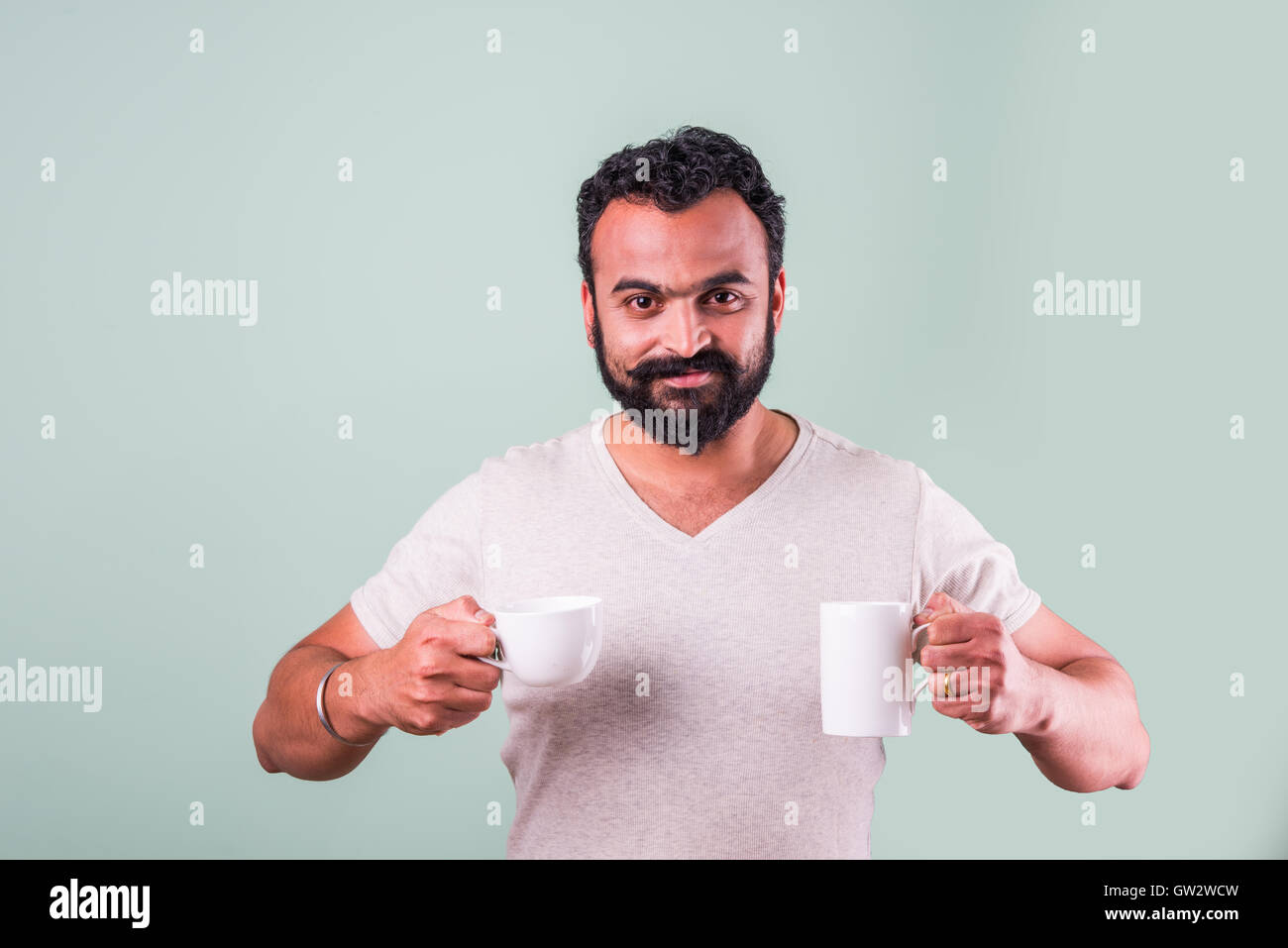 Indian or asian bearded young man or hipster in multiple activities isolated over plain background Stock Photo