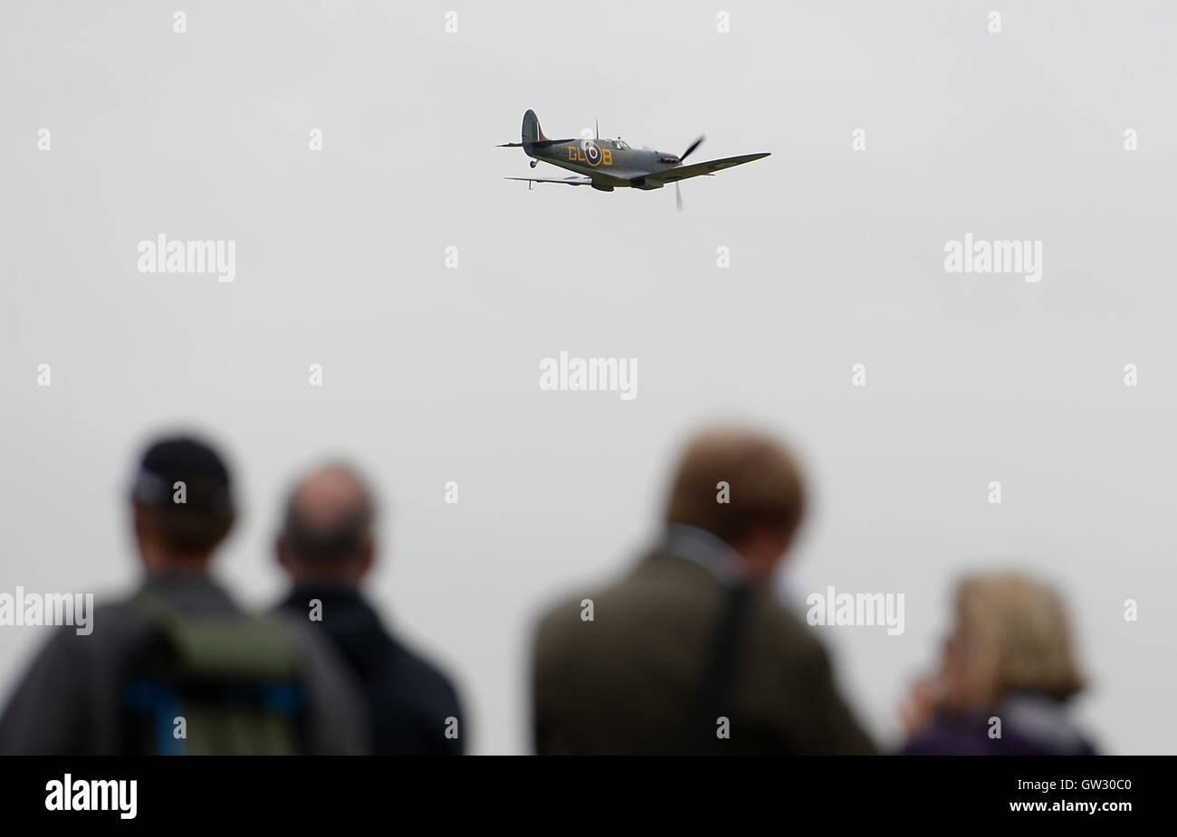 A Supermarine Spitfire Mk1a flies over the crowd during The Duxford Air Show 2016 at The Imperial War Museum in Duxford, Cambridgeshire. Stock Photo