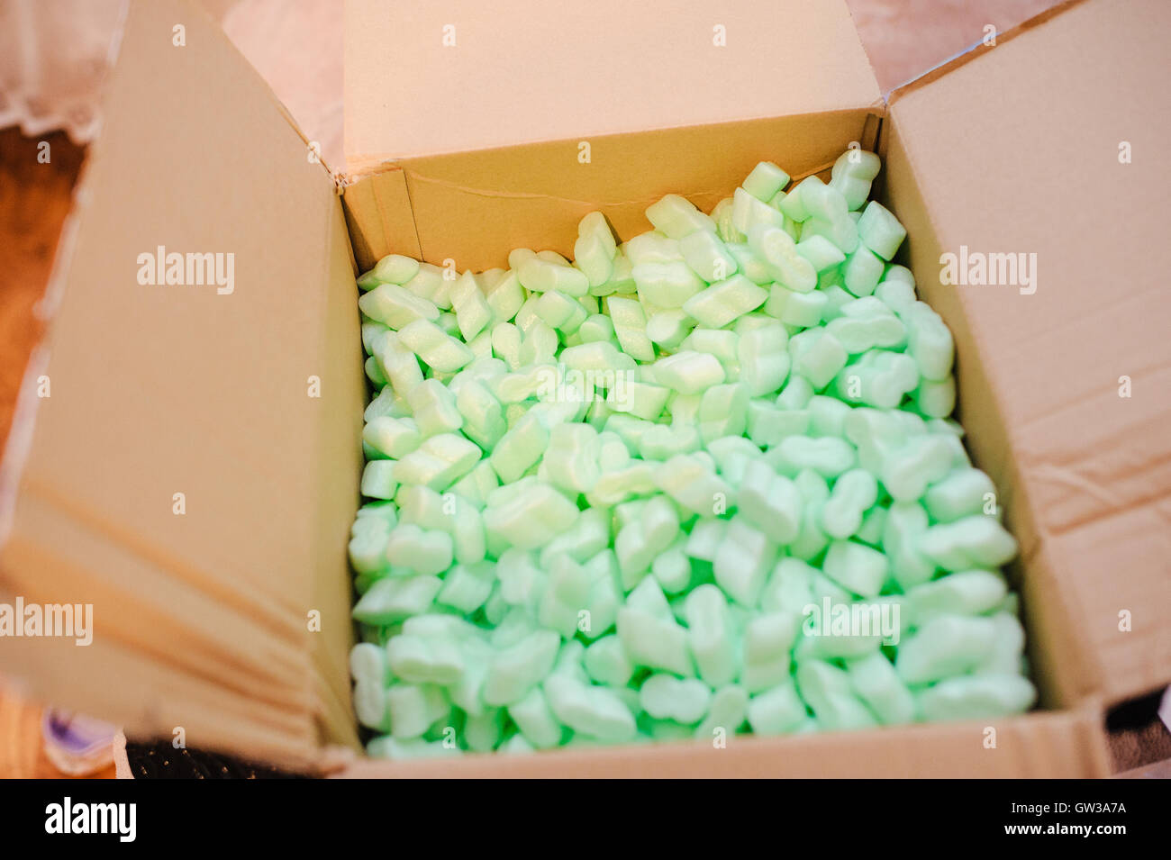 Large packaging box filled with many white styrofoam pellets Stock
