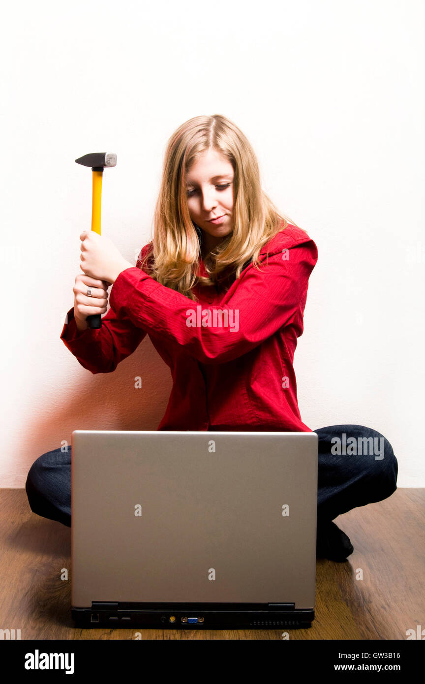 tween girl wanting to destroy her laptop with a hammer Stock Photo