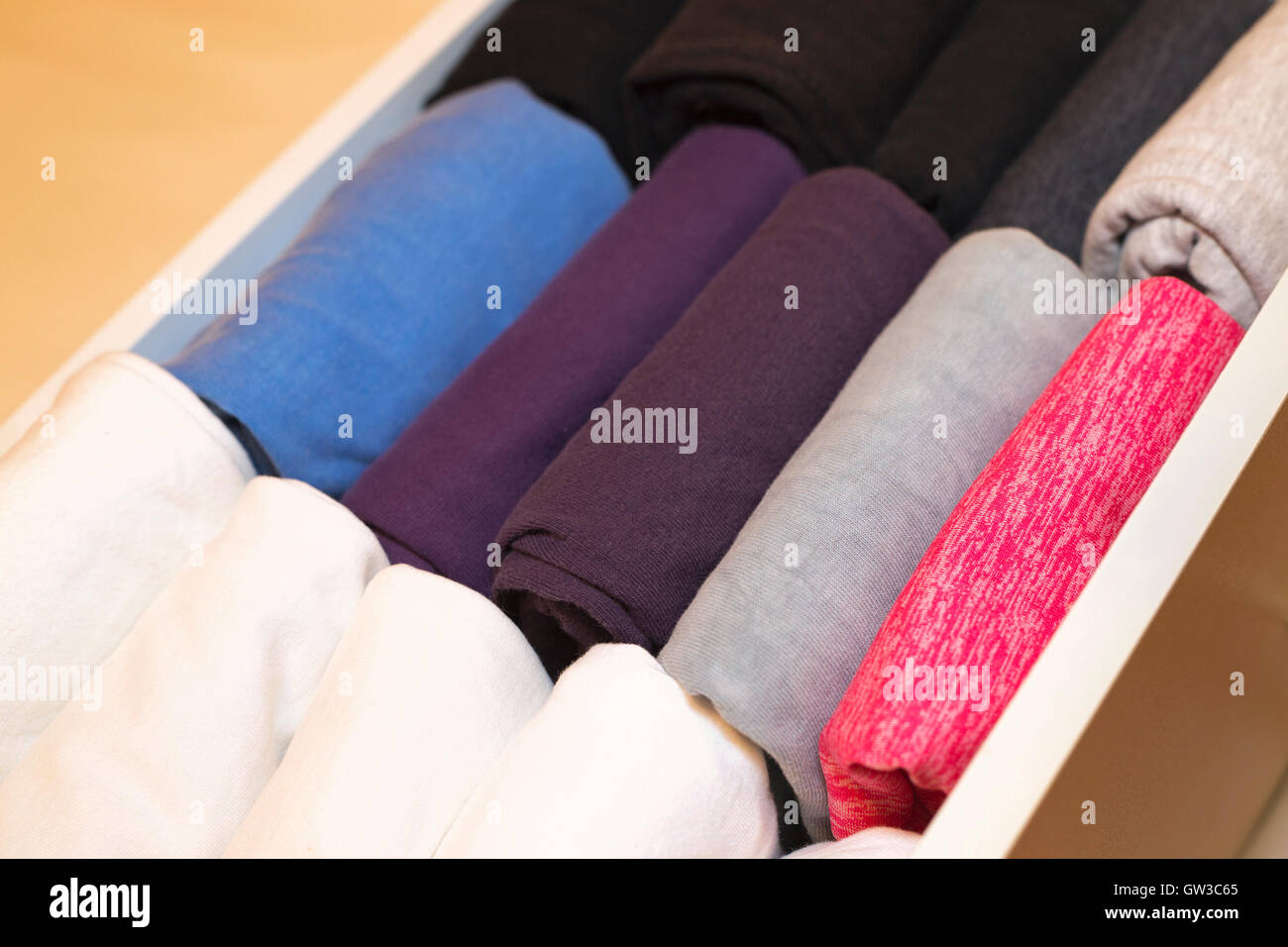 Woman's shirts in a bureau drawer folded in the KonMari method of home