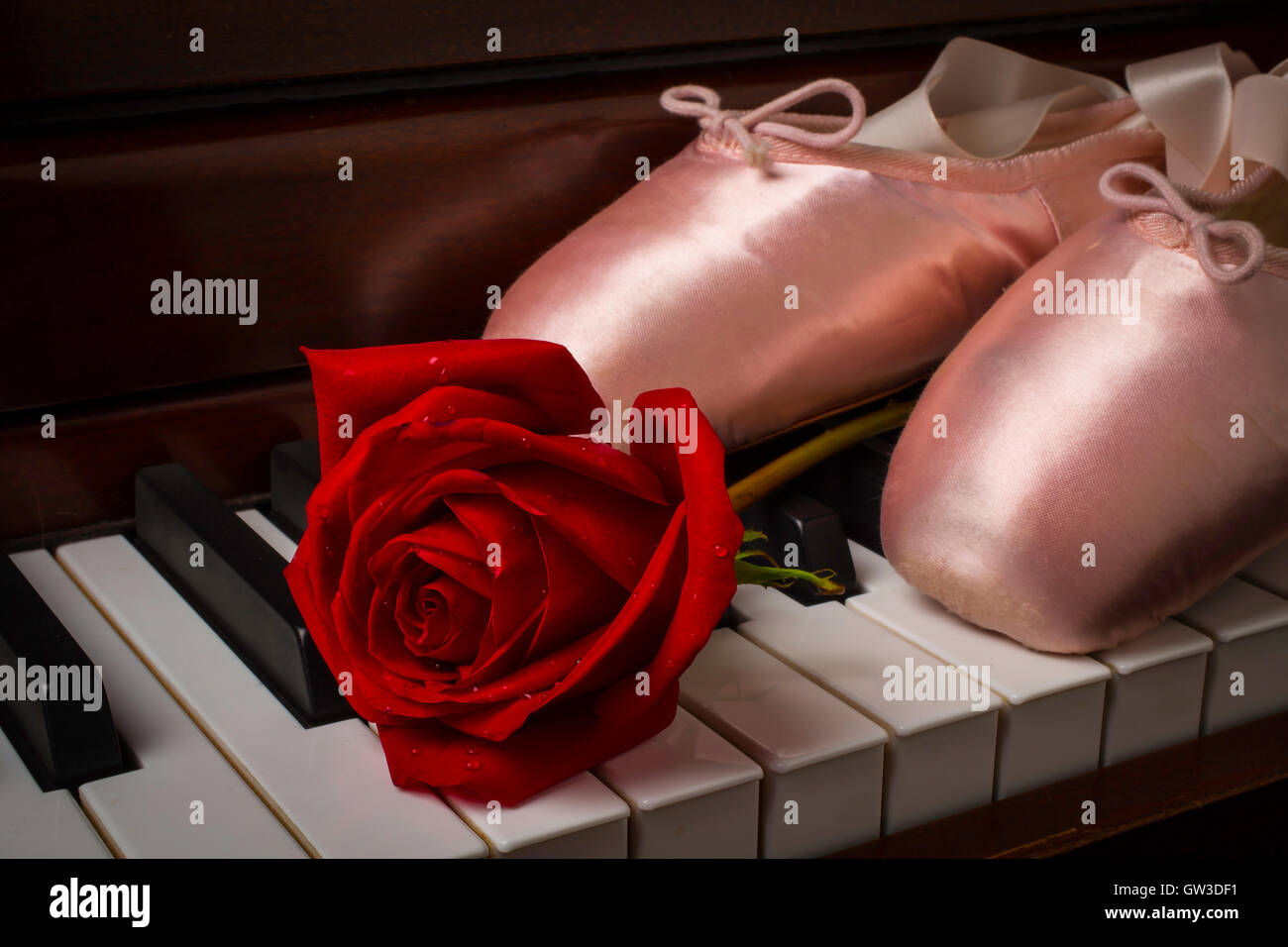 Rose And Ballet Shoes On Piano Stock Photo