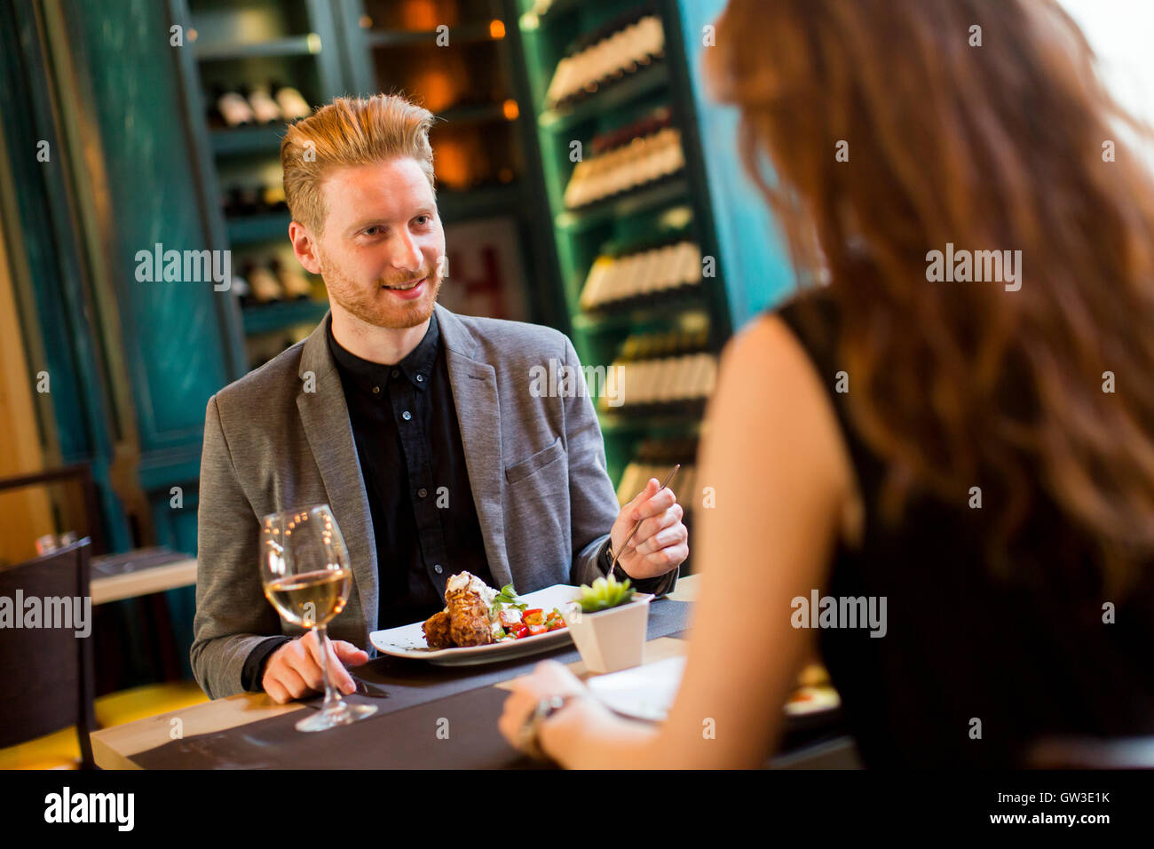 Handsome young redhair couple having dinner in the restaurant Stock Photo