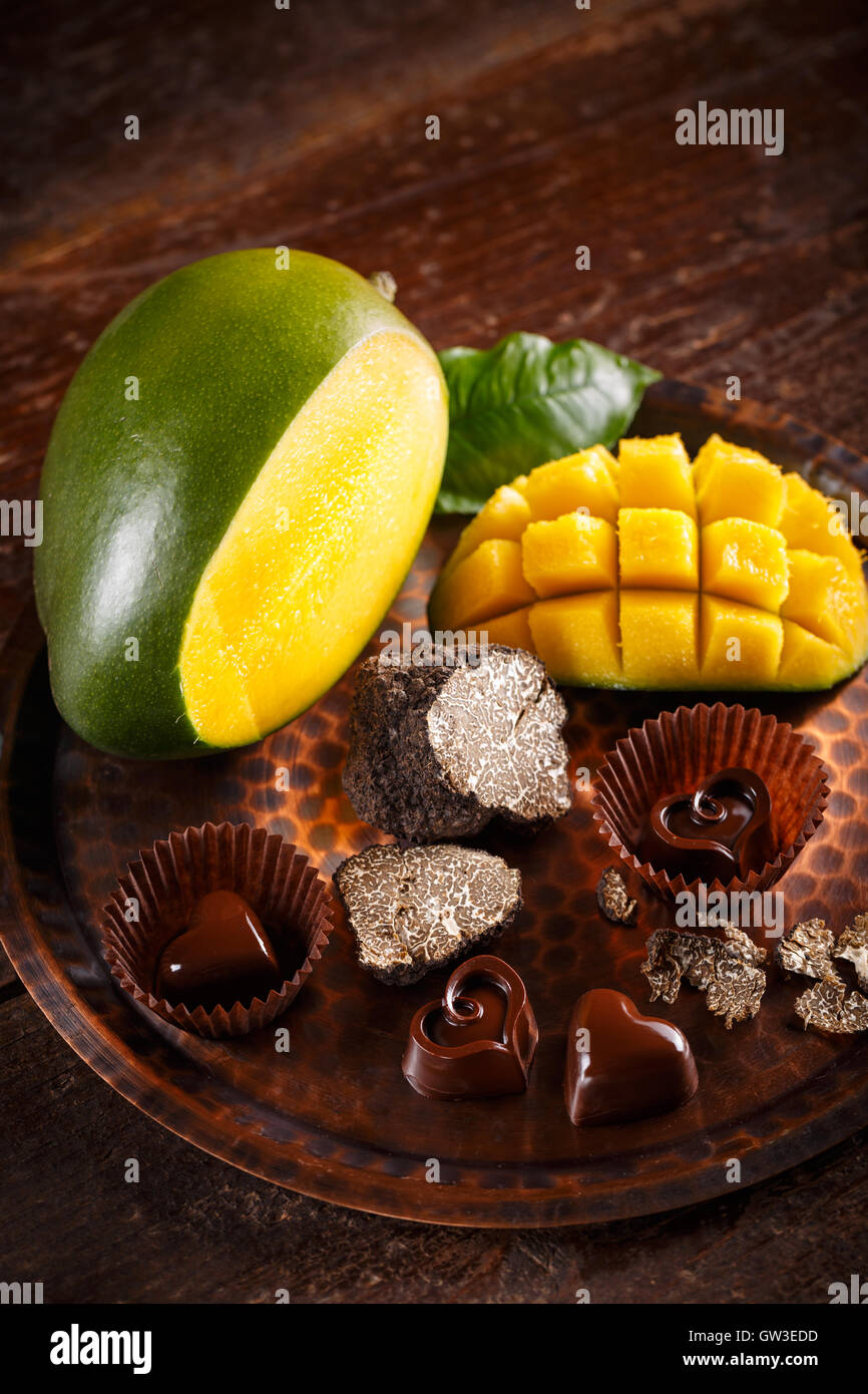 Dark chocolate praline with truffles and mango Stock Photo Alamy