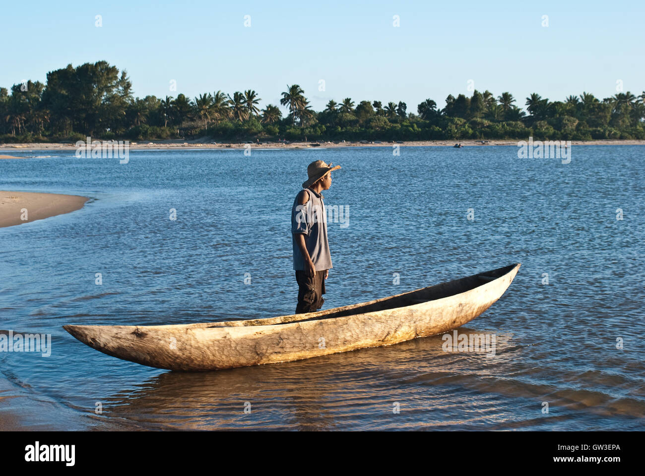 Boatman, pirogue, lake ( Madagascar) Stock Photo