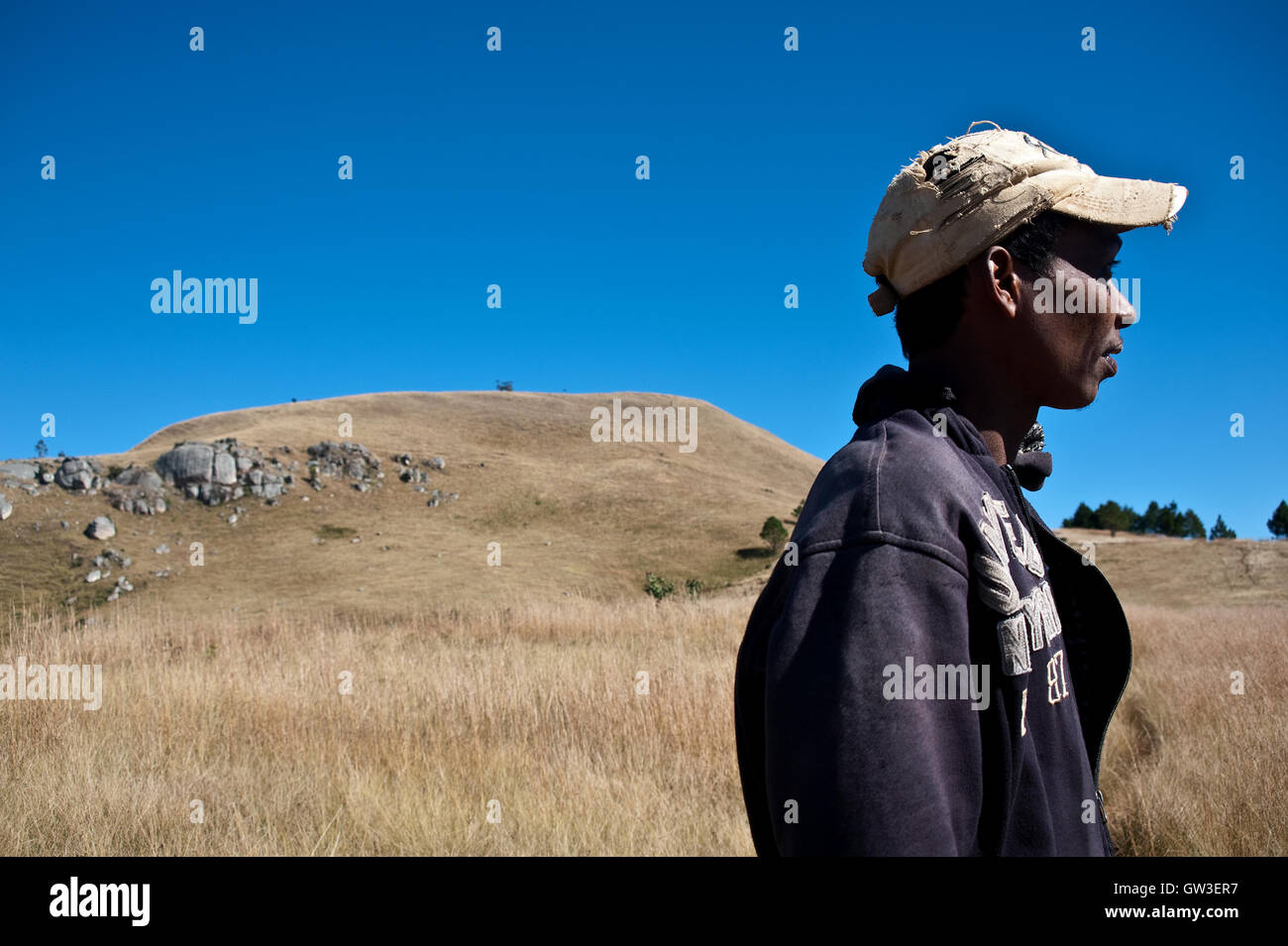 Young Betsileo man, sacred hill, landscape ( Madagascar central highlands) Stock Photo