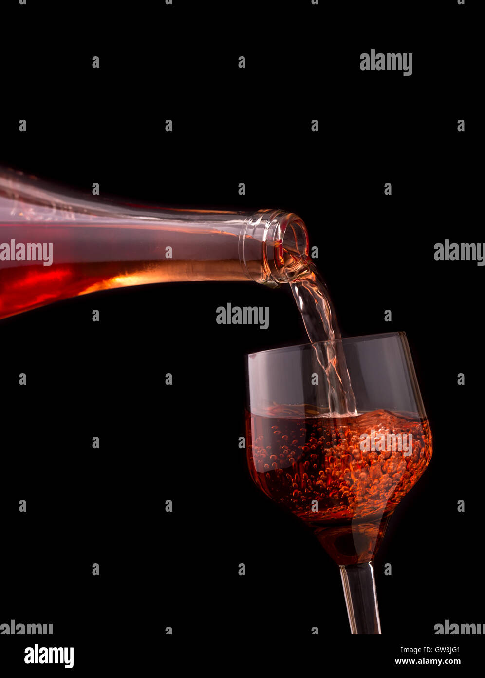 Pouring rose wine isolated on dark Stock Photo - Alamy