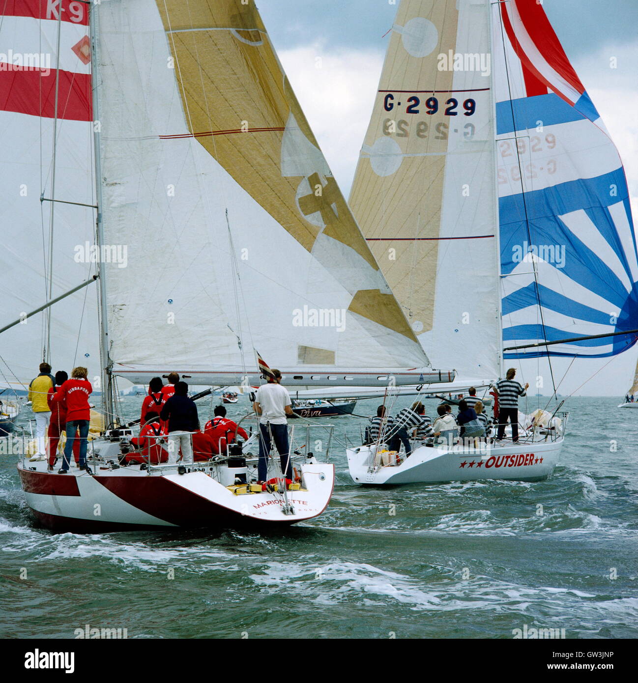 AJAXNETPHOTO. 1985. SOLENT, ENGLAND. - ADMIRAL'S CUP - SINGAPORE TEAM YACHT MARIONETTE AND GERMANY'S OUTSIDER.   PHOTO:JONATHAN EASTLAND/AJAX  REF:MARIONETTE 1985 Stock Photo
