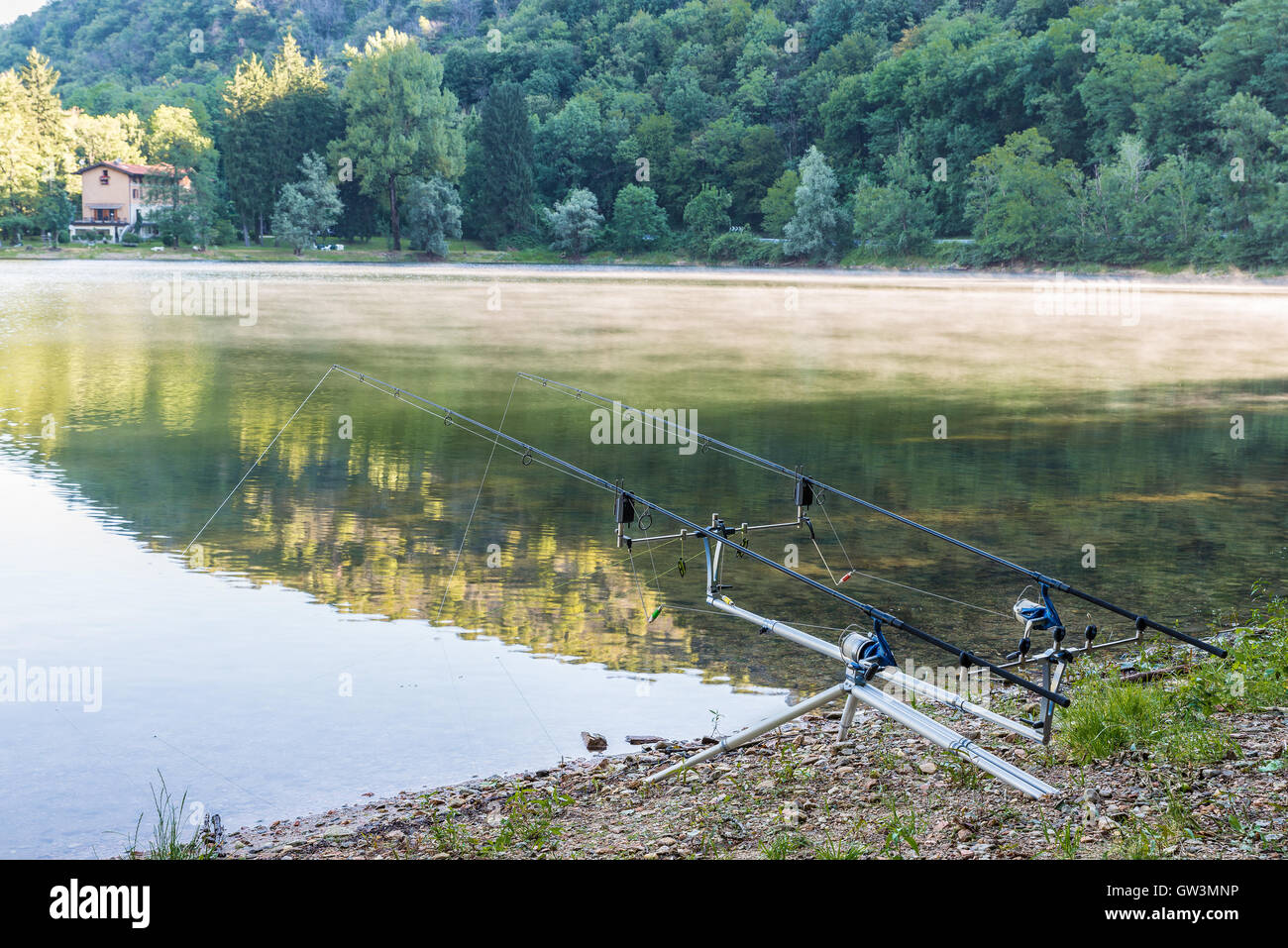 Fishing adventures. Carpfishing rods propped on a rod pod with two bite  alarms Stock Photo - Alamy