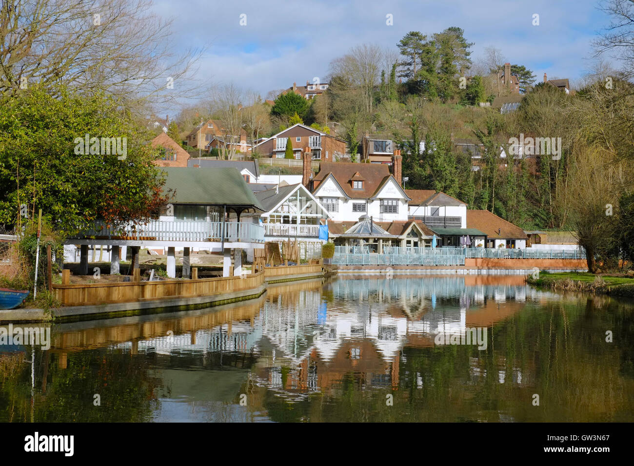 A beautiful view of the old boathouse reflected in the water, on the River Wey in Guildford, Stock Photo