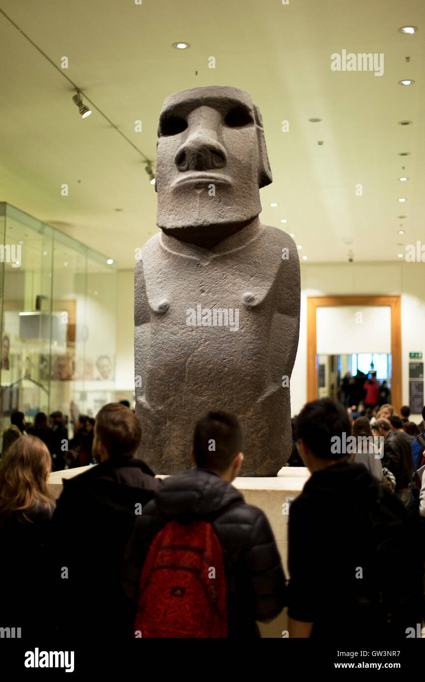 Tourists viewing a Moai (Easter Island) Statue, British Museum, London
