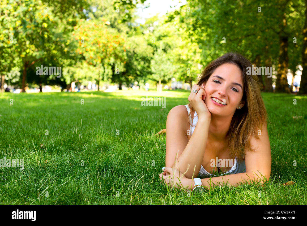 young woman lying in the park Stock Photo - Alamy
