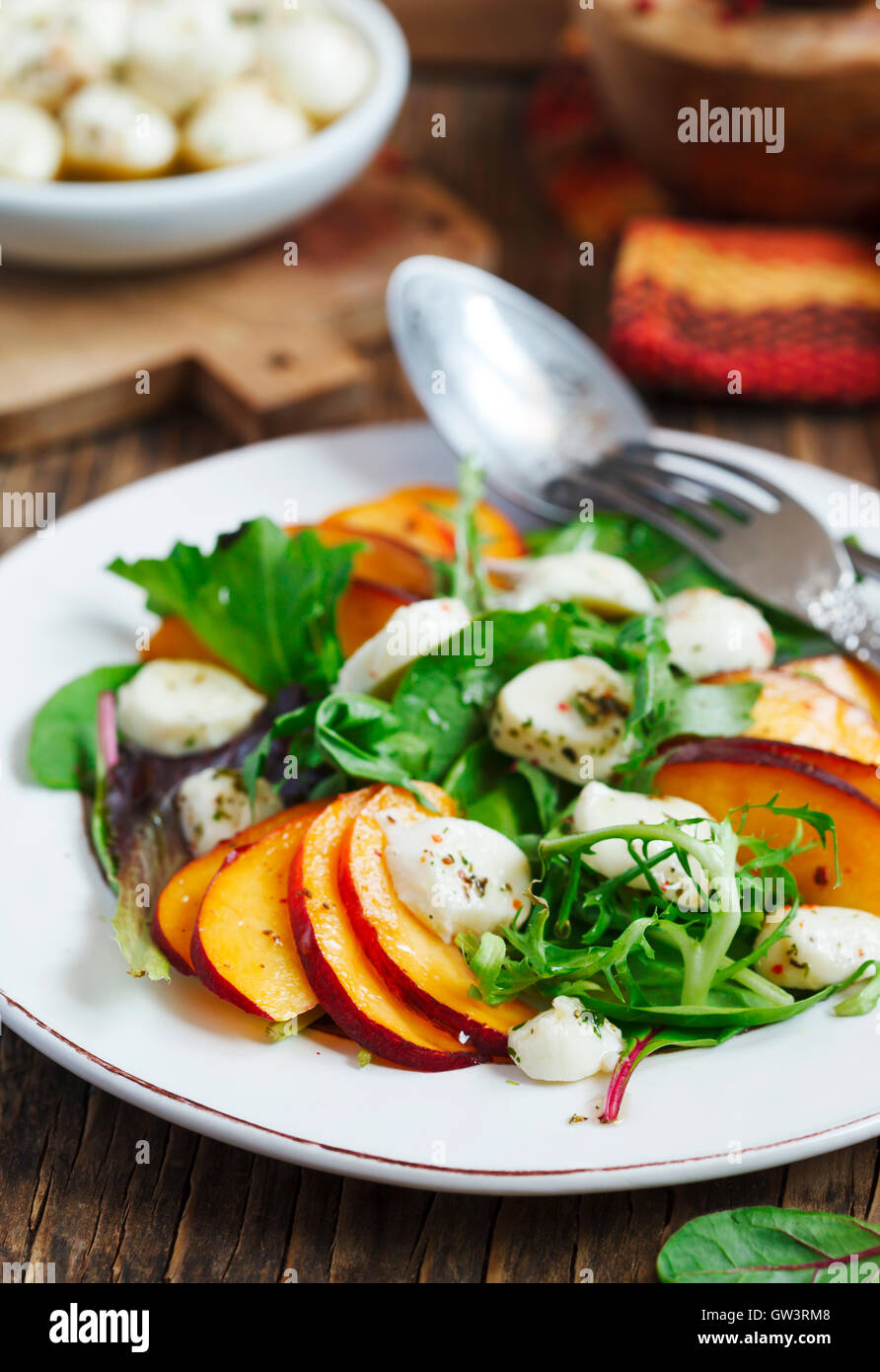 https://c8.alamy.com/comp/GW3RM8/peach-and-marinated-mozzarella-salad-with-fresh-mixed-greens-GW3RM8.jpg