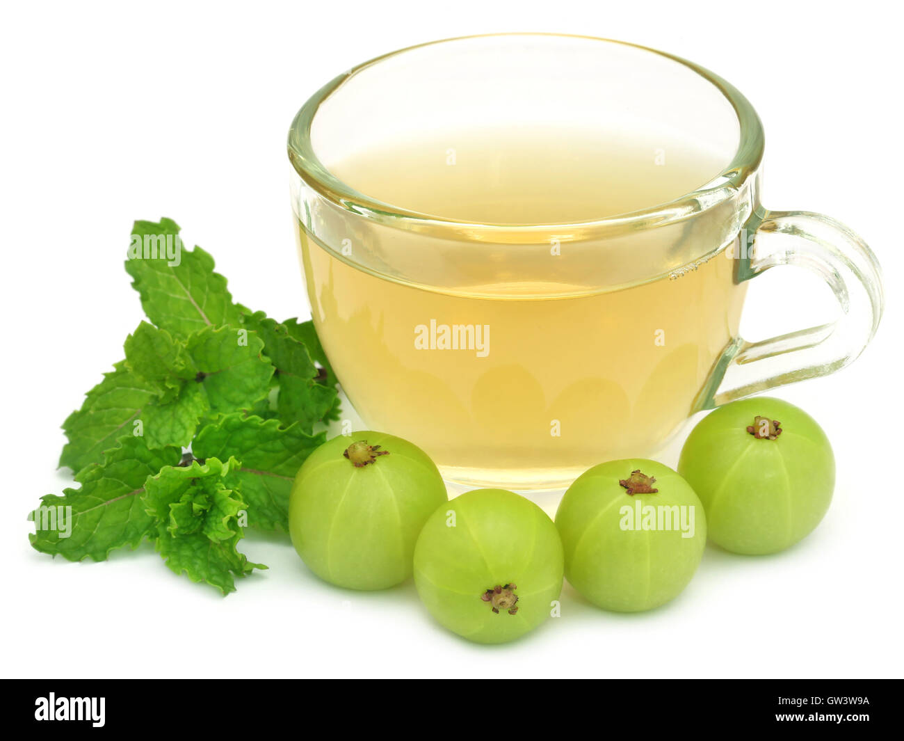 Herbal tea in a cup with amla and mint leaves Stock Photo