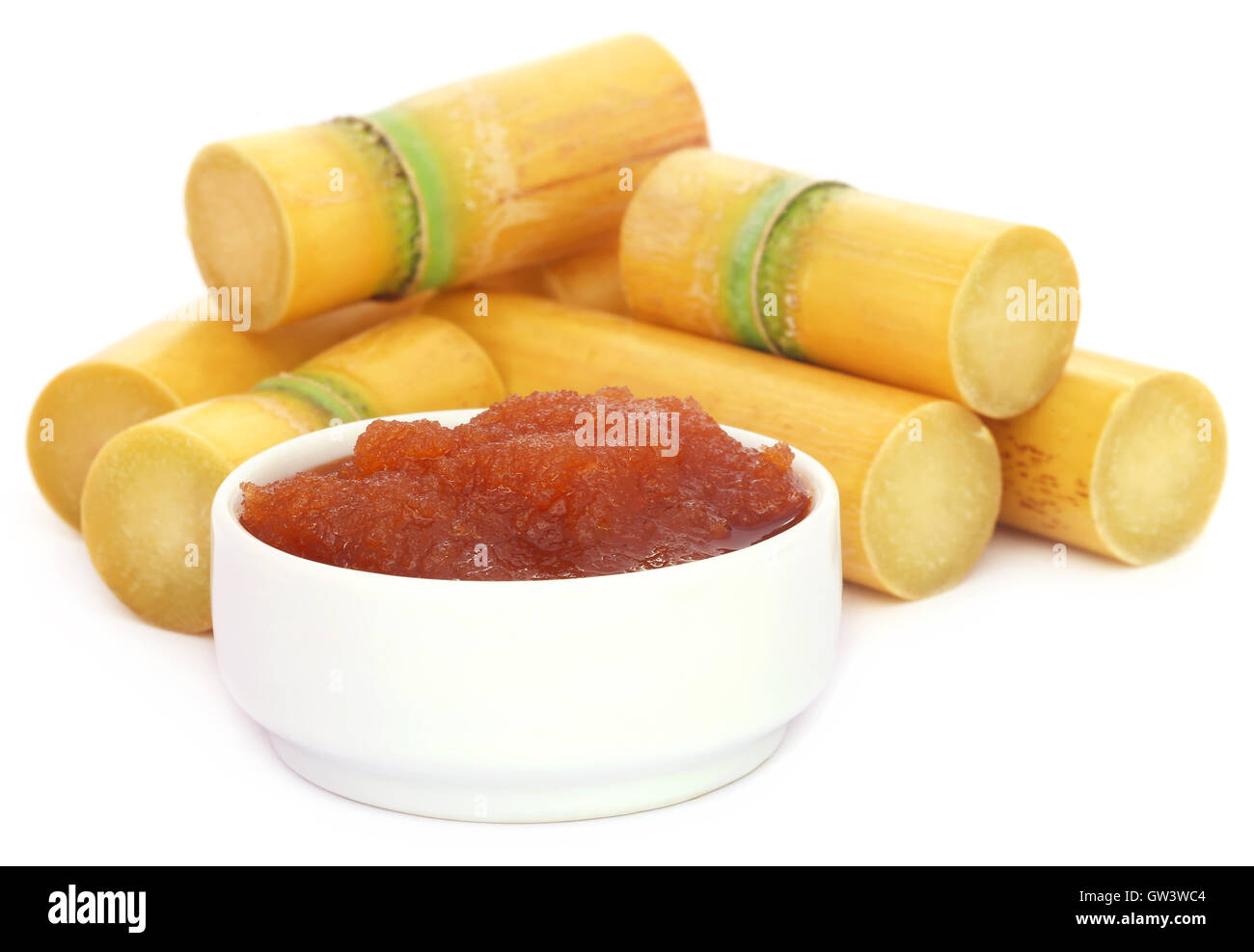 Molasses with sugarcane over white background Stock Photo Alamy