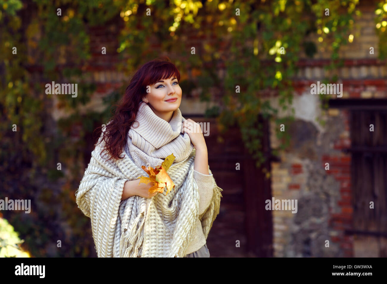 Beautiful girl outdoors with autumn leaves Stock Photo