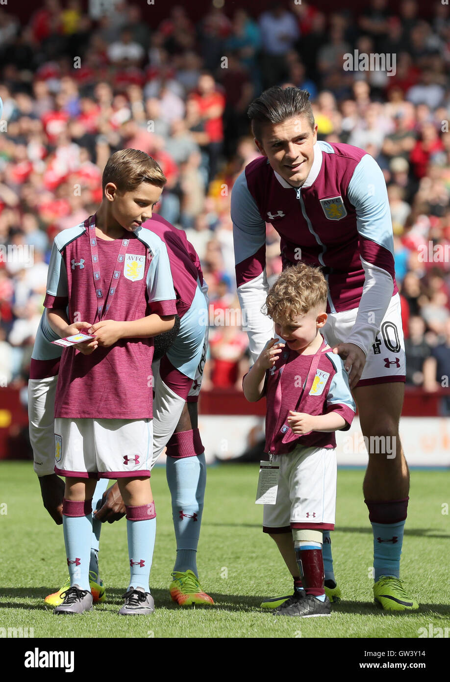 Aston Villa's Jack Grealish lines-up with mascot Carter Carrington during the Sky Bet Championship match at Villa Park, Birmingham. PRESS ASSOCIATION Photo. Picture date: Sunday September 11, 2016. See PA story soccer Villa. Photo credit should read: Martin Rickett/PA Wire. RESTRICTIONS: Editorial use only. Maximum 45 images during a match. No video emulation or promotion as 'live'. No use in games, competitions, merchandise, betting or single club/player services. No use with unofficial audio, video, data, fixtures or club/league logos. Stock Photo