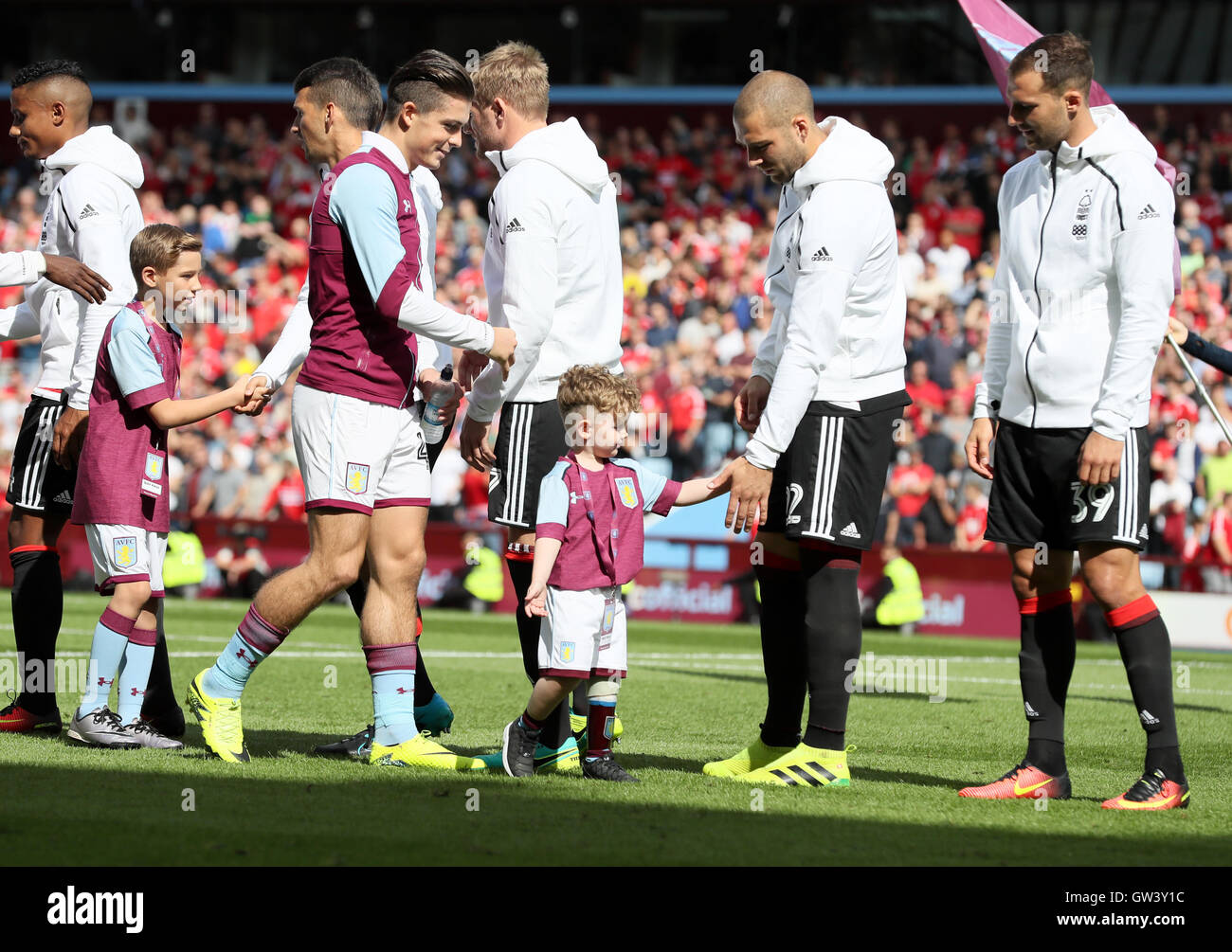 Aston Villa's Jack Grealish lines-up with mascot Carter Carrington during the Sky Bet Championship match at Villa Park, Birmingham. PRESS ASSOCIATION Photo. Picture date: Sunday September 11, 2016. See PA story SOCCER Villa. Photo credit should read: Martin Rickett/PA Wire. RESTRICTIONS: Editorial use only. Maximum 45 images during a match. No video emulation or promotion as 'live'. No use in games, competitions, merchandise, betting or single club/player services. No use with unofficial audio, video, data, fixtures or club/league logos. Stock Photo