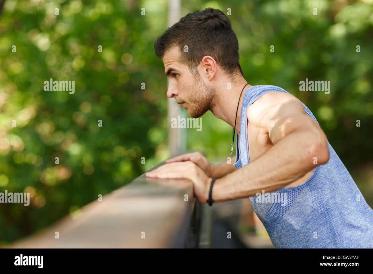Young athlete doing push-ups on exercise in park Stock Photo - Alamy
