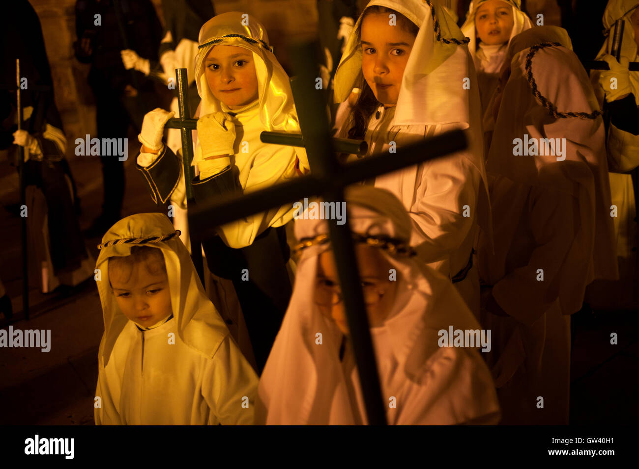 Children dressed as Hebrews and holding crosses during an Easter Holy Week procession in Astorga, Castilla y Leon, Spain. Stock Photo