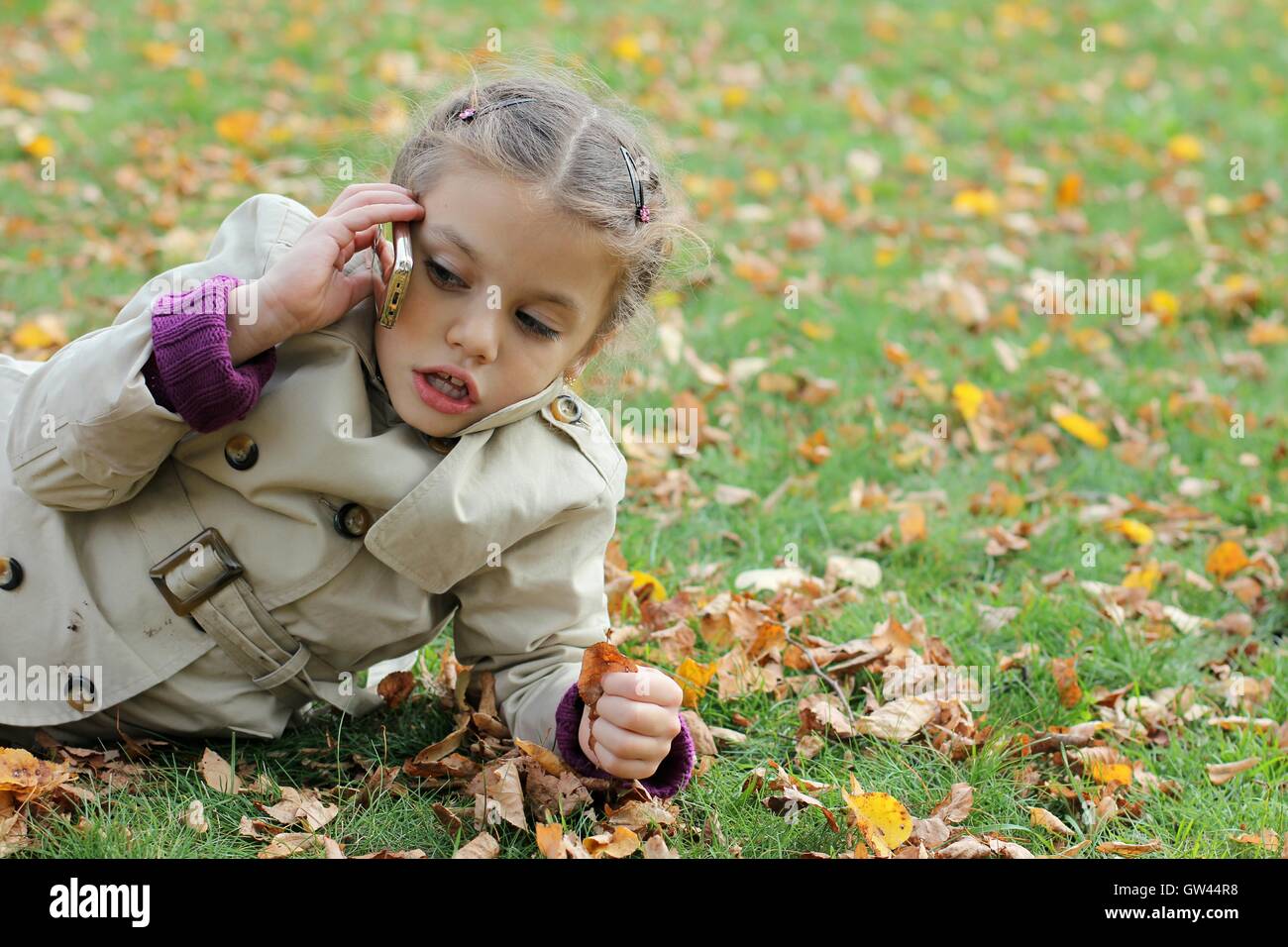 little girl in the autumn park Stock Photo - Alamy